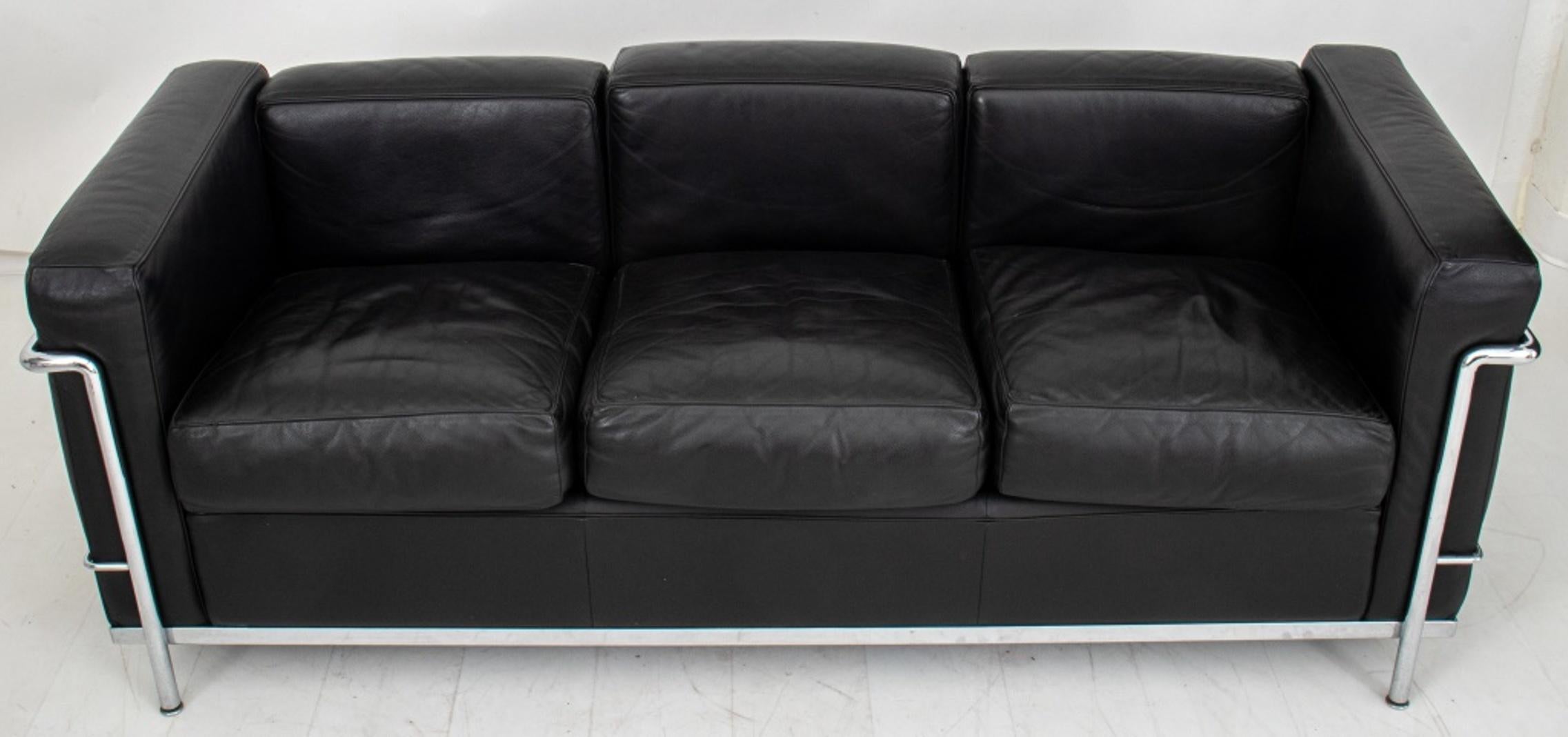 Cassina Le Corbusier (Swiss-French, 1887-1965) LC2 three seat sofa, designed 1928, this example 1990s, of typical form with black leather and chrome fittings. 

Dimensions: 26