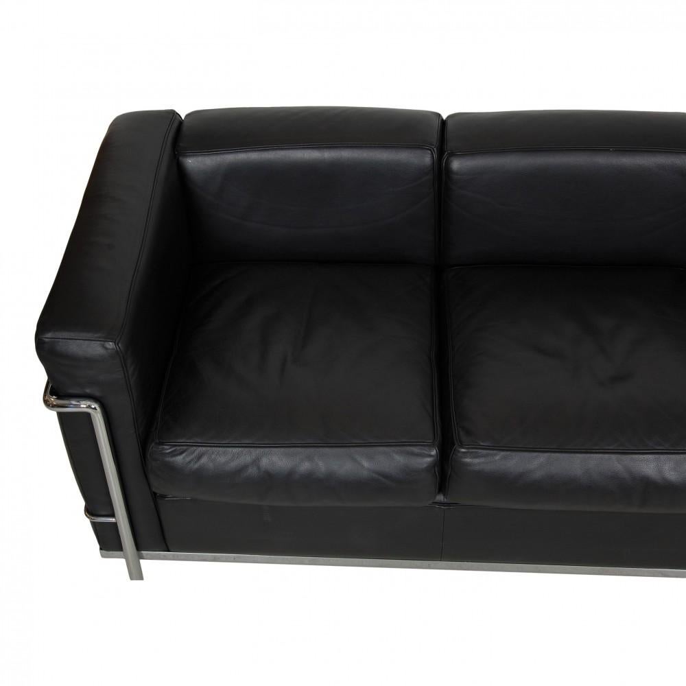 Le Corbusier LC2/3-seater sofa in black leather and steel frame, which appears in a slightly patinated condition without holes in the leather and without rust on the frame. All sofas are from the same place and in the same condition and from around