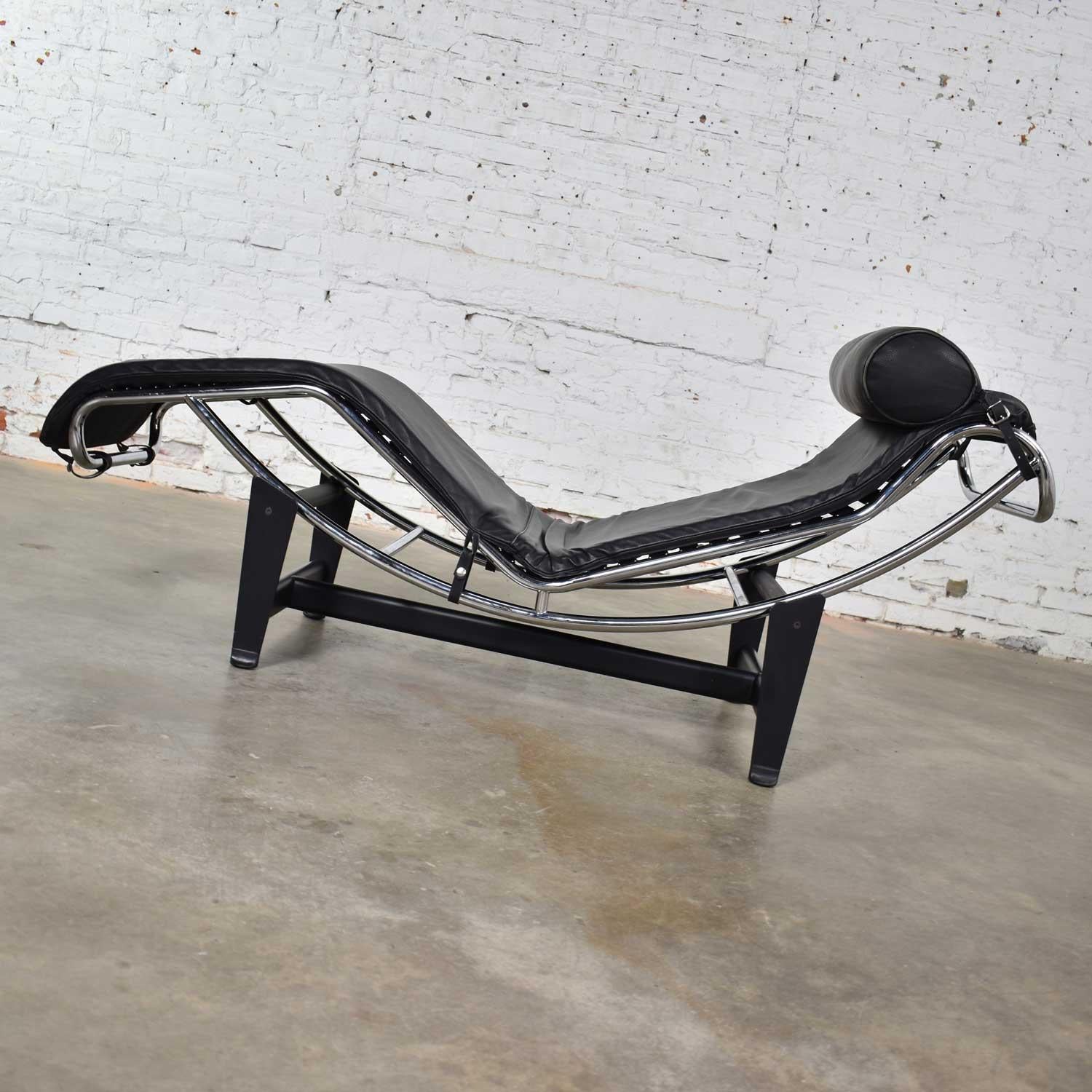 Wonderful Le Corbusier LC4 style chaise in chrome and black painted steel with black leather cushion and head support. This example is by an unknown maker. It is in fabulous vintage condition. It does have a couple worn spots in the ribbed rubber