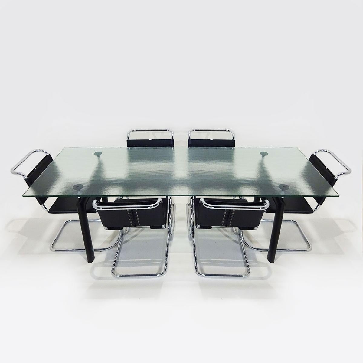 Vintage iconic dining set featuring a Le Corbusier textured glass Cassina LC6 table matched to 6 chrome and black leather Mies van der Rohe MR10 dining chairs by Knoll.

Designed within the same period in the late 1920s this iconic set is a