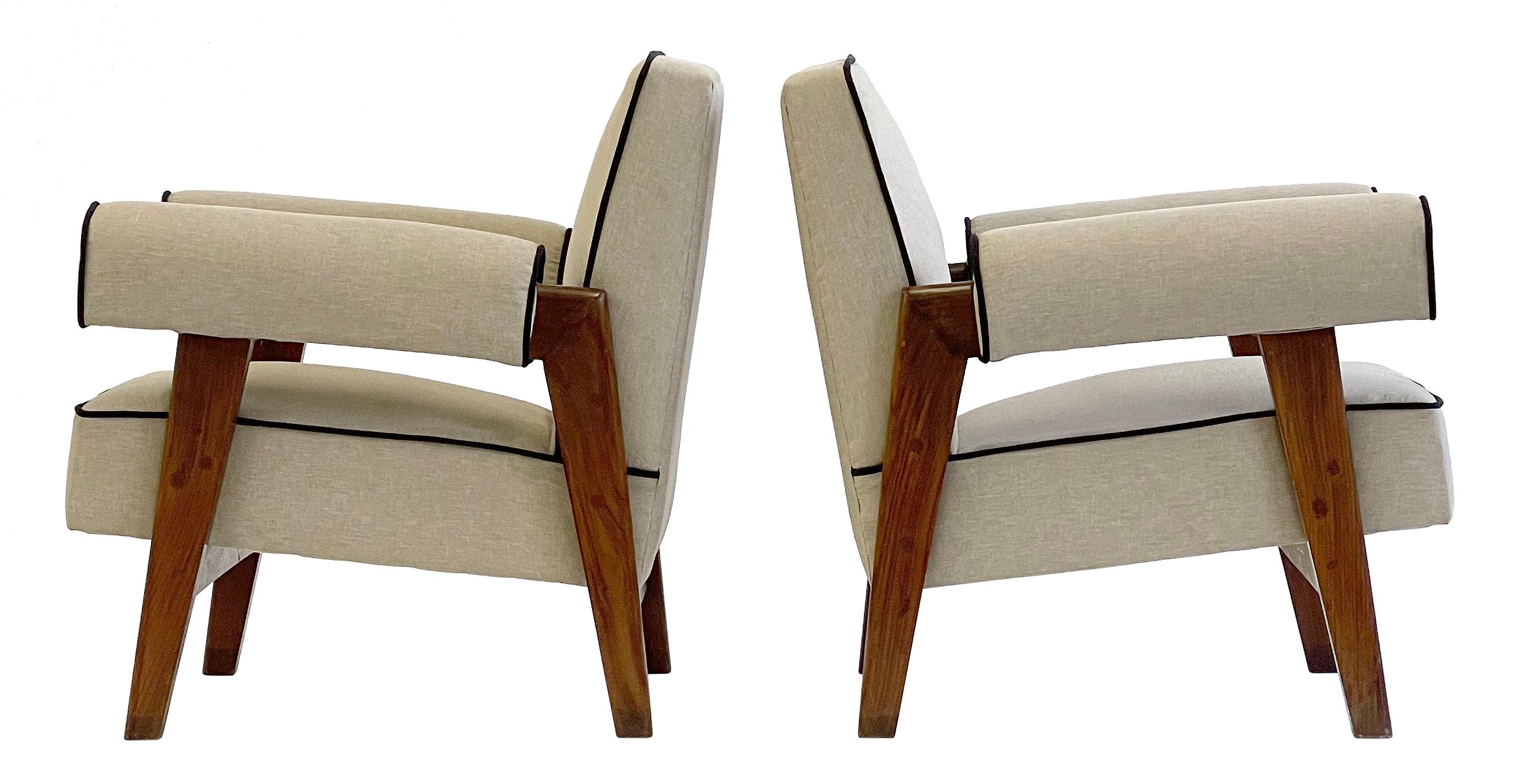 An important pair of upholstered lounge chairs in solid teak. A rare authentic vintage pair of lounge chairs designed by Le Corbusier and Pierre Jeanneret, circa 1955.

These chairs are having fresh upholstery in a light linen with darker piping.