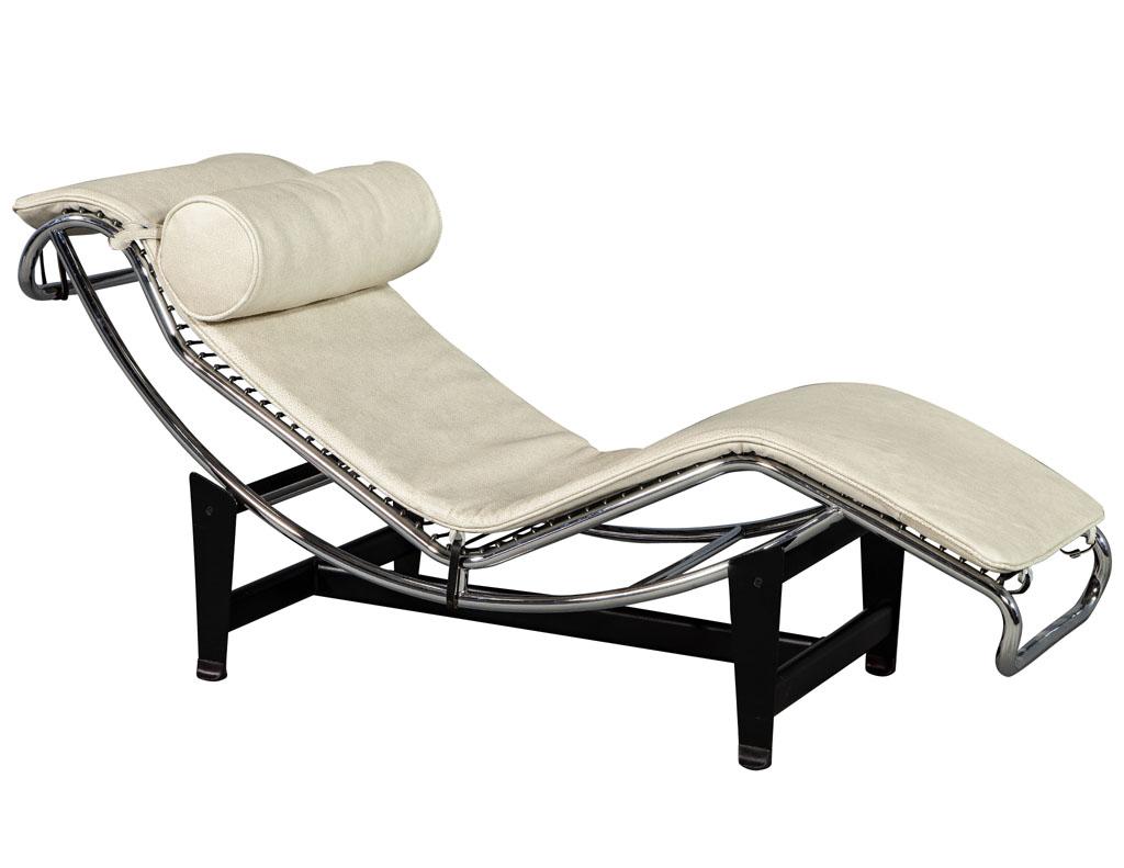 Le Corbusier style leather and polished stainless steel chaise. Attributed to Le Corbusier, it is crafted out of rich cream leather with a padded roll headrest for comfort. Sleek in design, the black metal base is a perfect complement with a