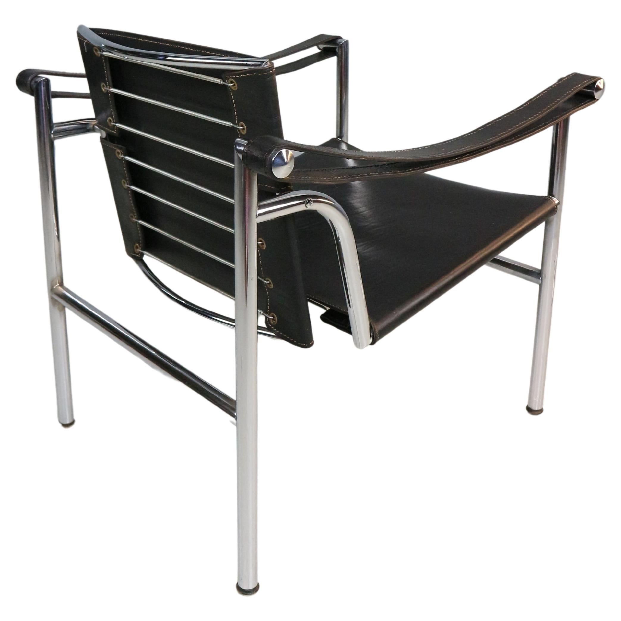 Iconic armchair designed by Le Corbusier and manufactured for Cassina, famous Italian furniture manufacture in 1970s period.
The chair is original signed. 
Model number- LC1.
Chrome tubular frame and black original leather seating.
The back of the