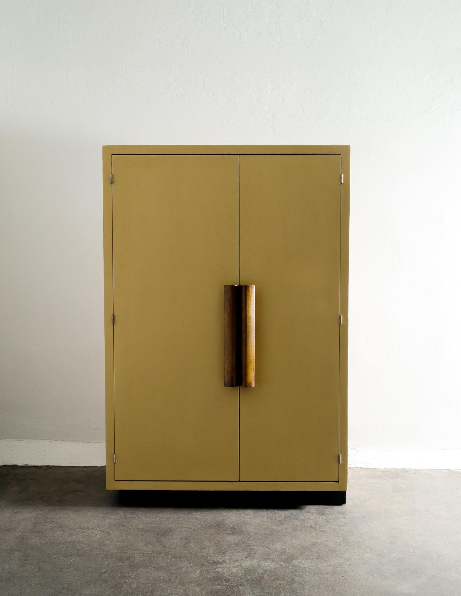 Very rare and iconic midcentury wardrobe / dresser / closet designed by Le Corbusier for apartments of the Cité radieuse housing unit in Marseille 1949. In very nice and charmy condition with the lacquered wood and stained oak handles. Doors are in