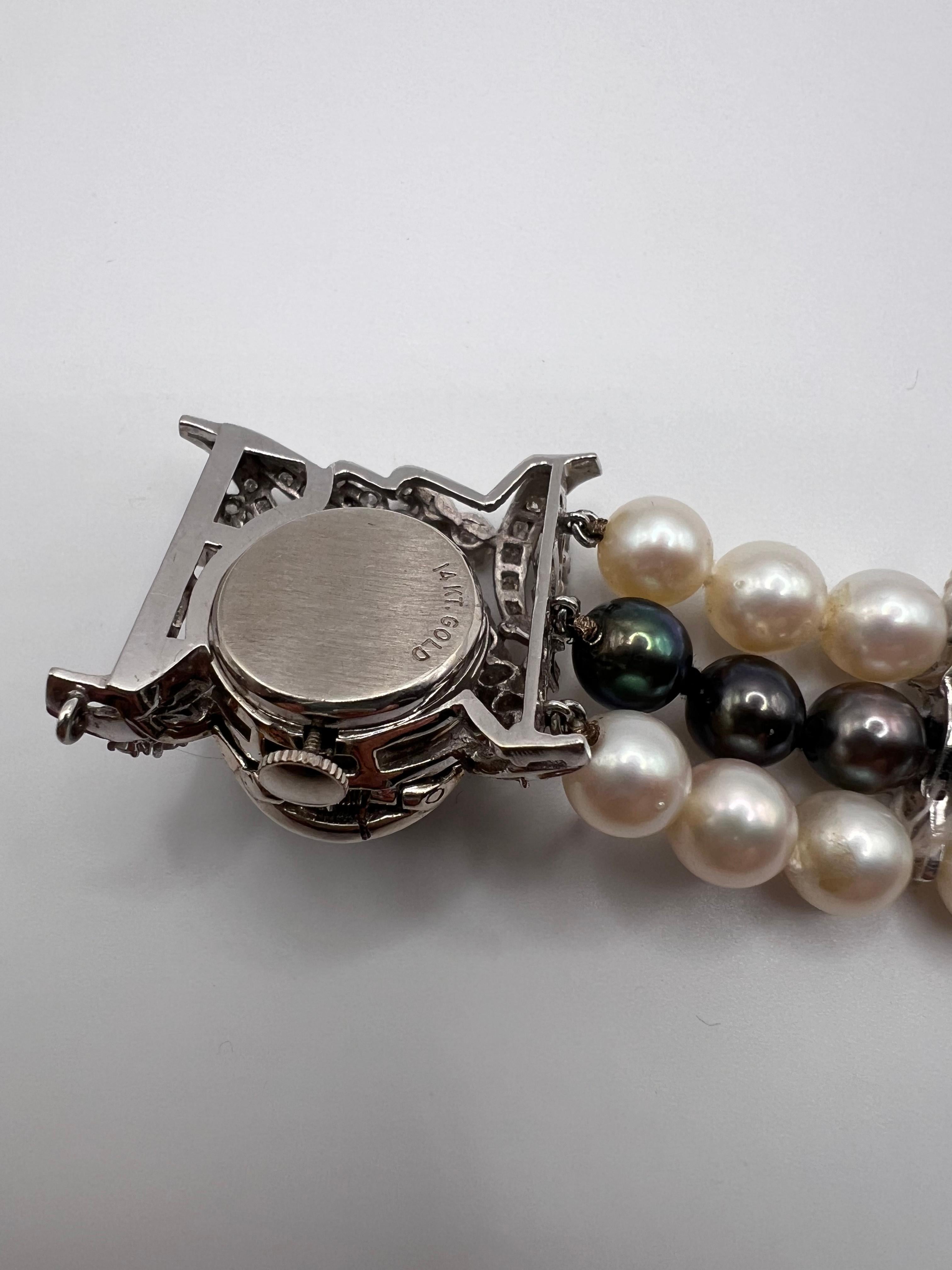 This exquisite Le Courie 14k White Gold Covered Watch from the 1950s is a remarkable fusion of elegance and artistry. Crafted in 14k white gold, this vintage piece is adorned with a striking combination of black and white pearls—with the white