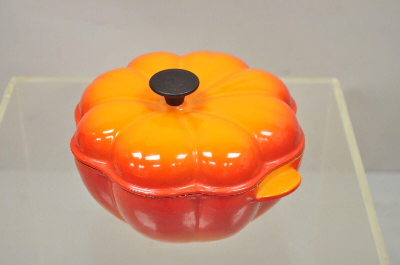 Le Creuset France orange cast iron 2 qt Dutch oven pumpkin shape pot. Circa late 20th century. Measurements: 6