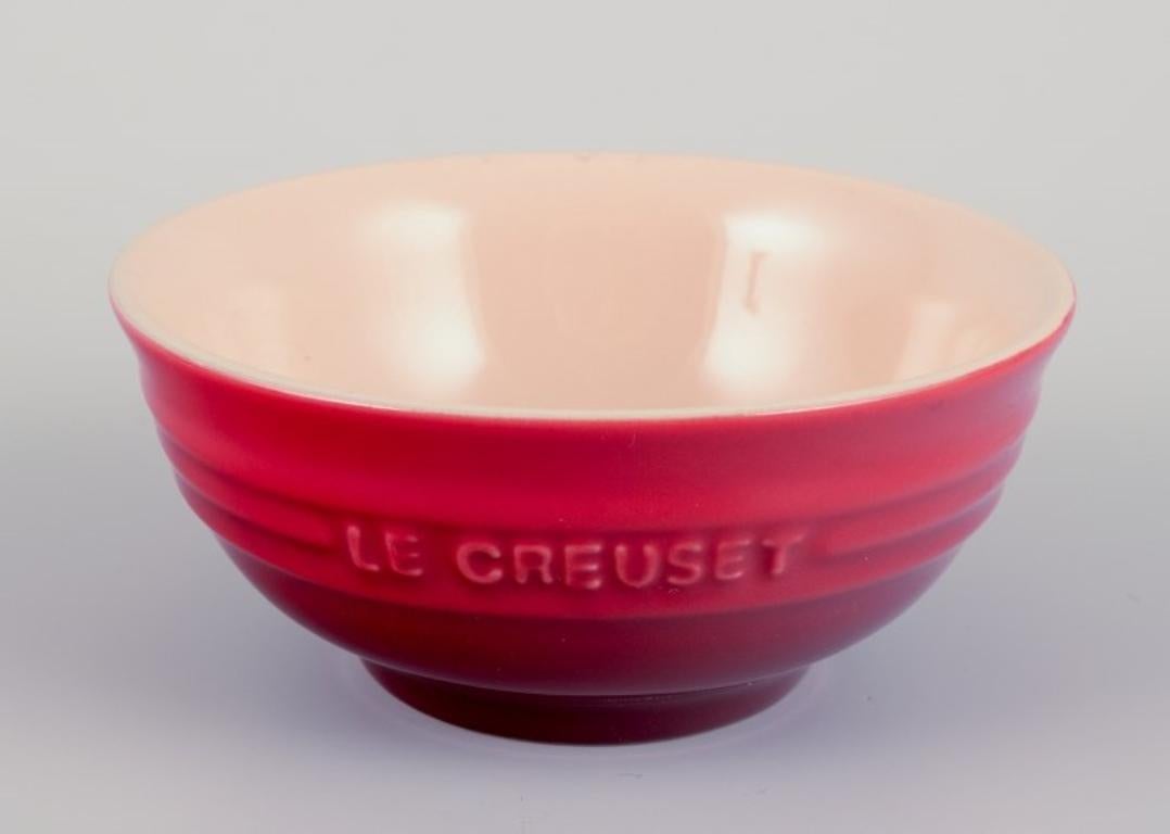Glazed Le Creuset, France. Set of five red stoneware bowls. 21st c. For Sale