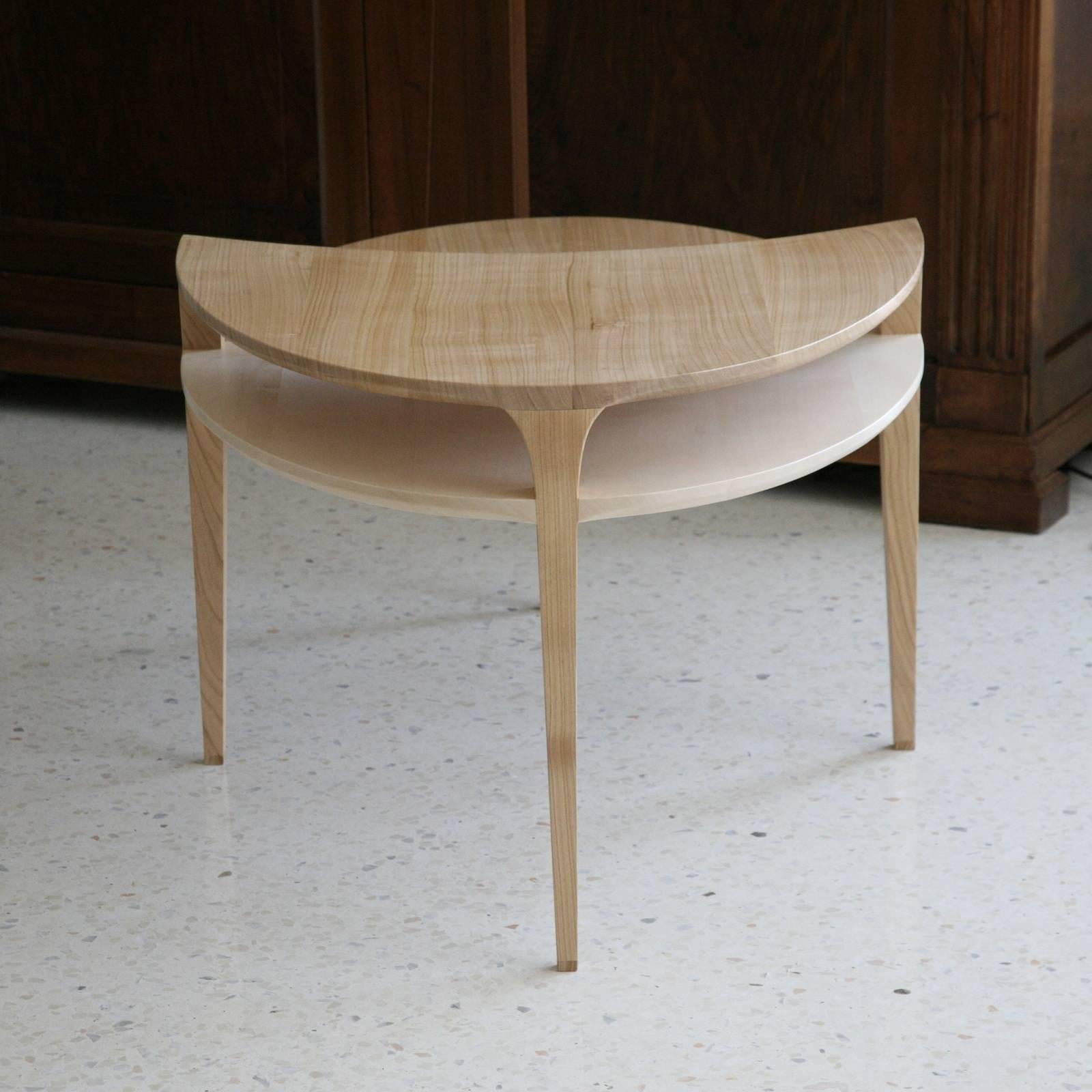 An exquisite example of contemporary design and masterful craftsmanship, this coffee table will enrich a modern living room, becoming its focal point. Its oval shape rests on four slightly tapered legs, two of which raise to support the elevated