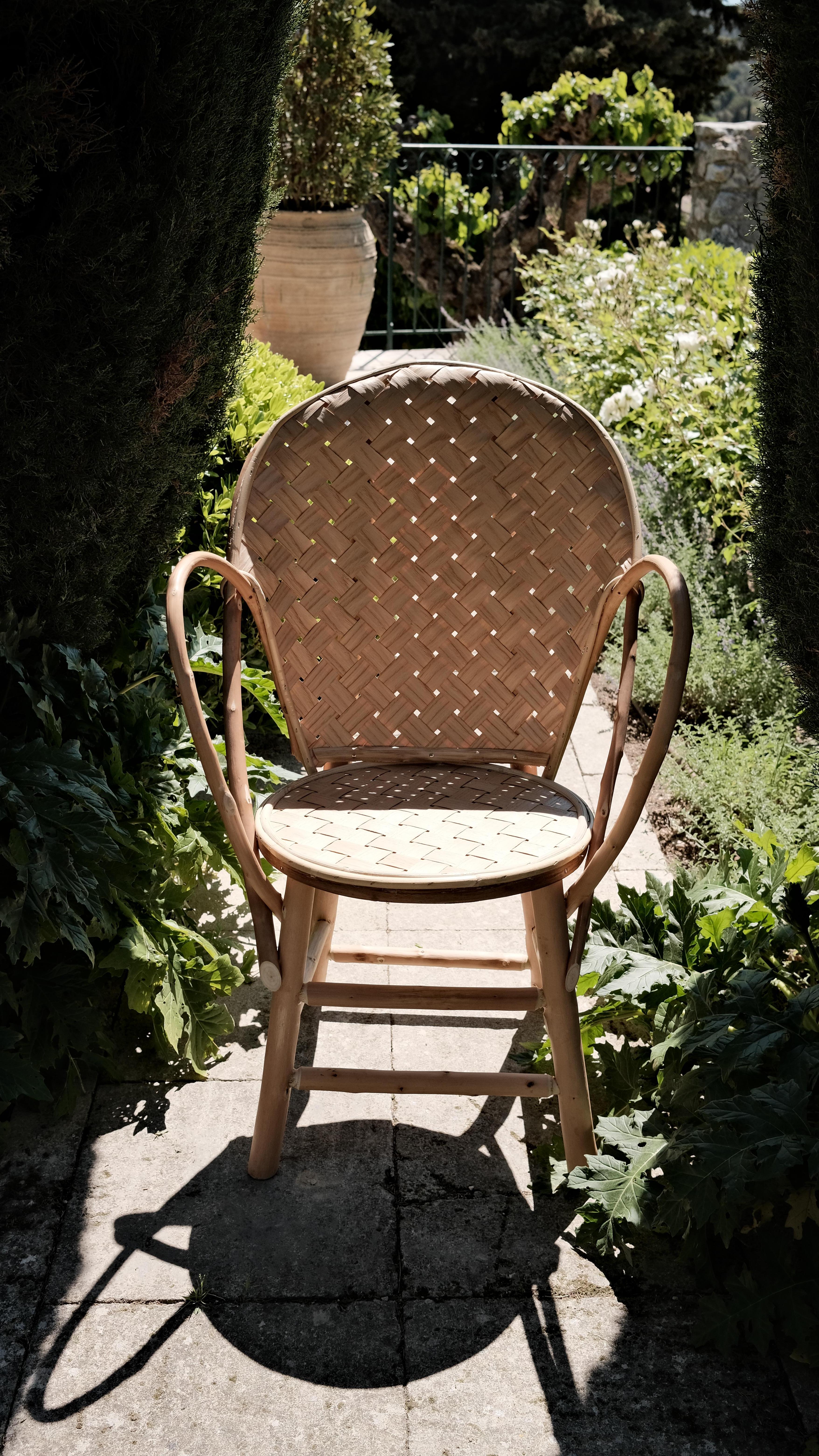 Le Fauteuil Classique Chair by Bosc Design
Dimensions: W 70 x D 42 x H 94 cm 
Materials: Wood.

The elegant and curved structure is covered with a magnificent braiding of chestnut sides on the seat and back. Handcrafted in France, each armchair is