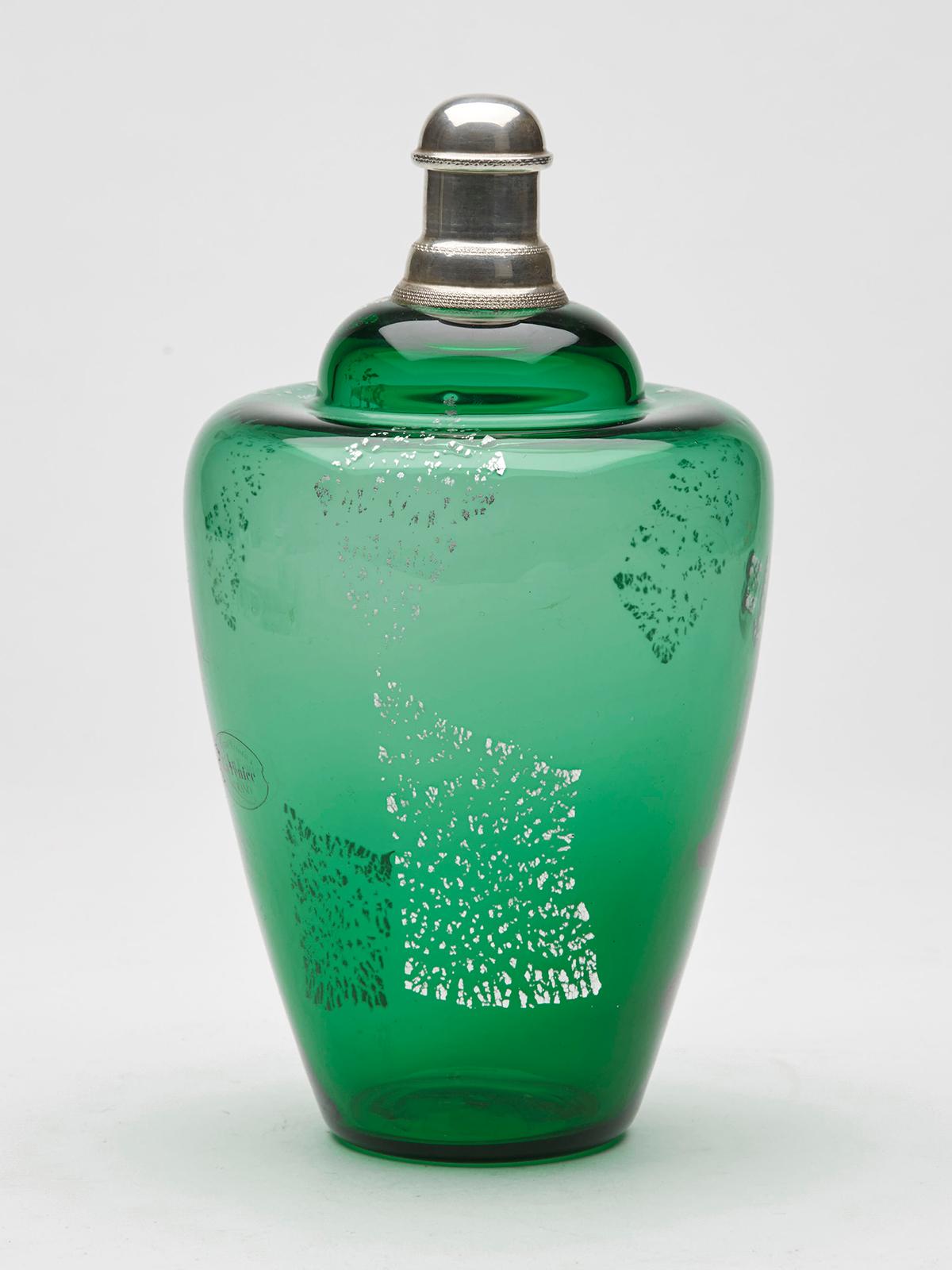 A stylish vintage La Fenice, Murano green glass cologne bottle with silver mounted top and screw cover and with silver aventrine inclusions running through the green glass body by Veteria Artistica La Fenice and probably darting from around 1960.