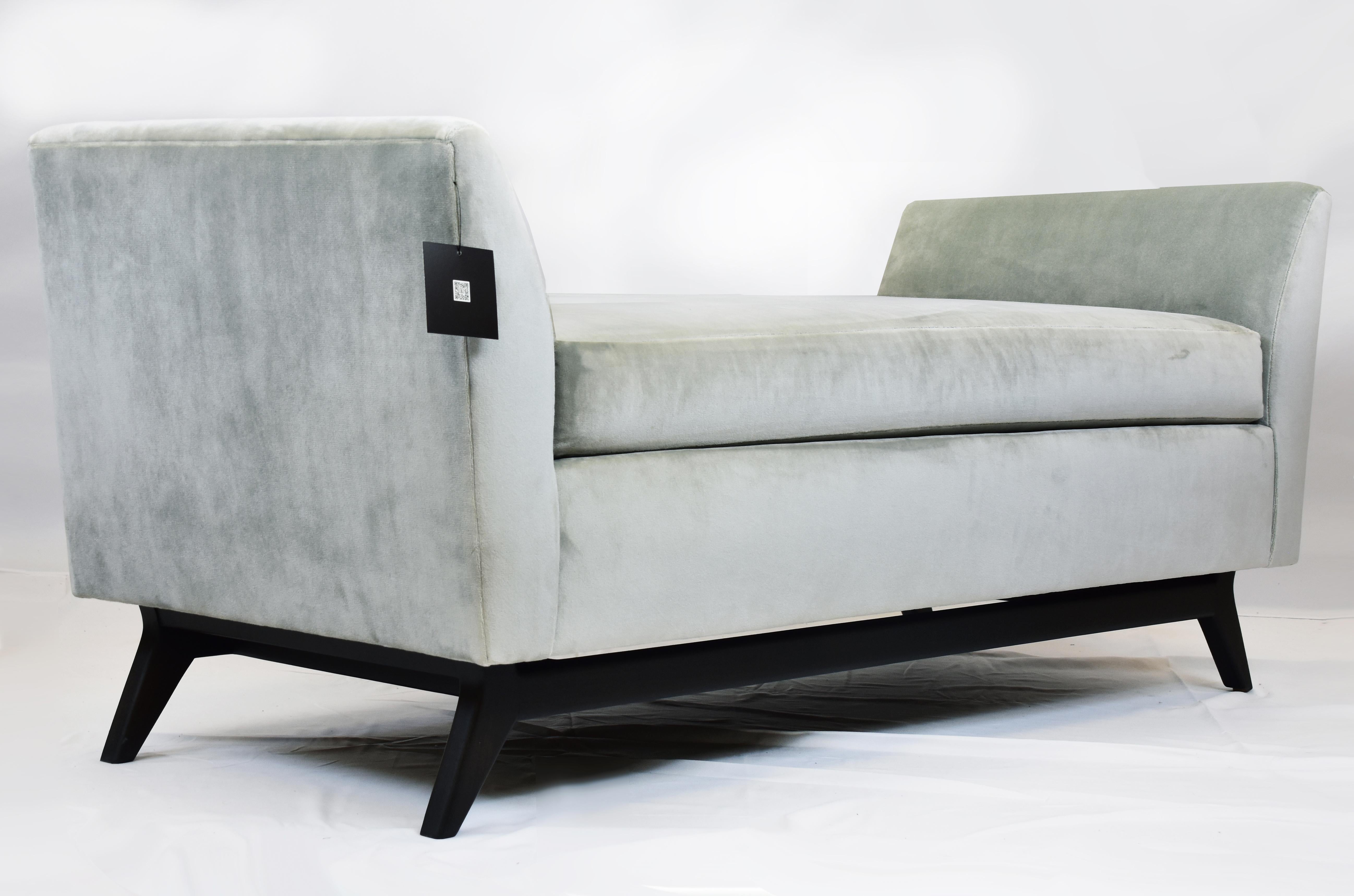 Le Jeune Upholstery Melina Bench Showroom Model in Velvet and Walnut

Offered for sale is a MELINA	B3.923 Bench showroom model.	The bench is inspired by the designs of the mid-century modern era having slight flared arms and an angled Walnut wood