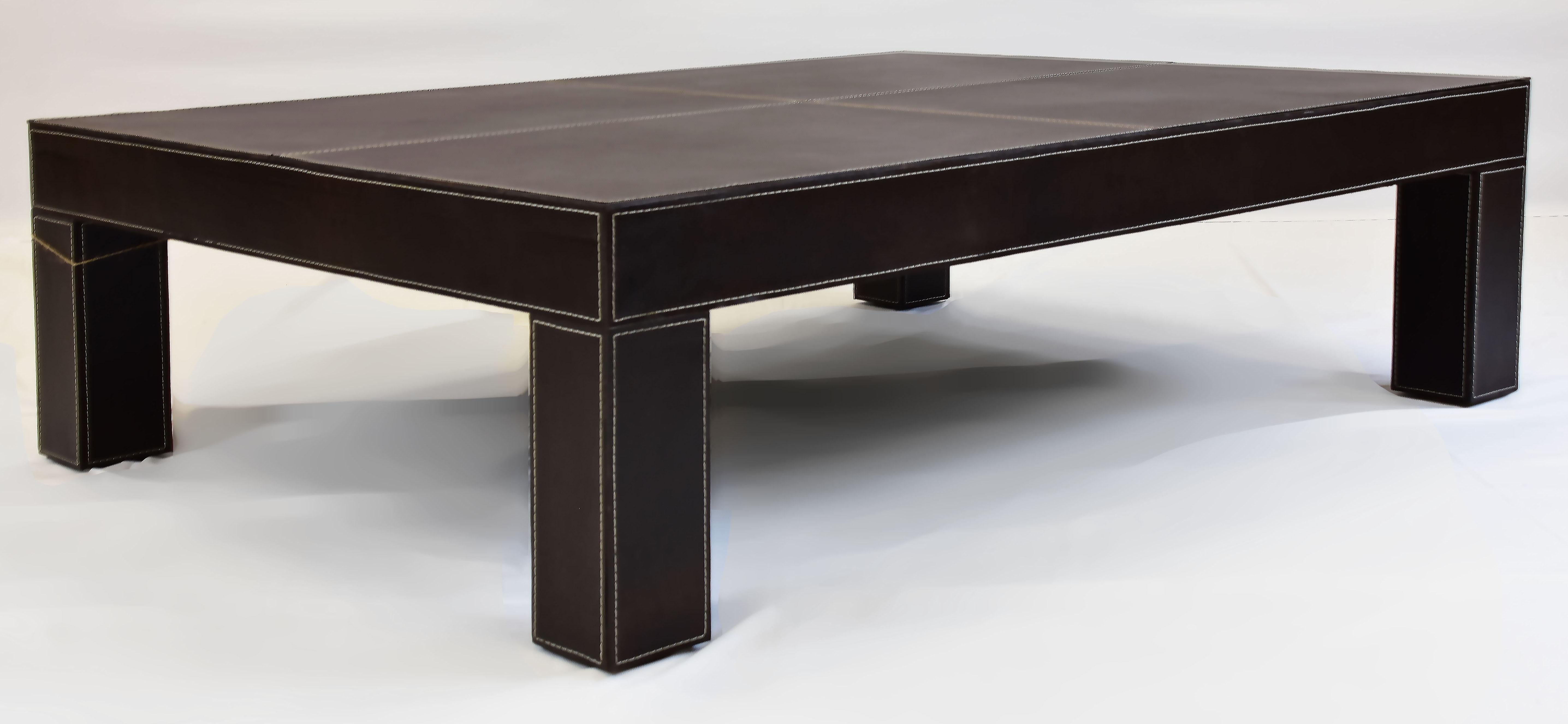 Le Jeune Upholstery Saddle Up Leather Coffee Table Showroom Model

Offered for sale is a  Le Jeune Upholstery SADDLE UP stitched leather clad coffee table showroom model.	The cocktail table is covered in a thick premium dark brown saddle leather,