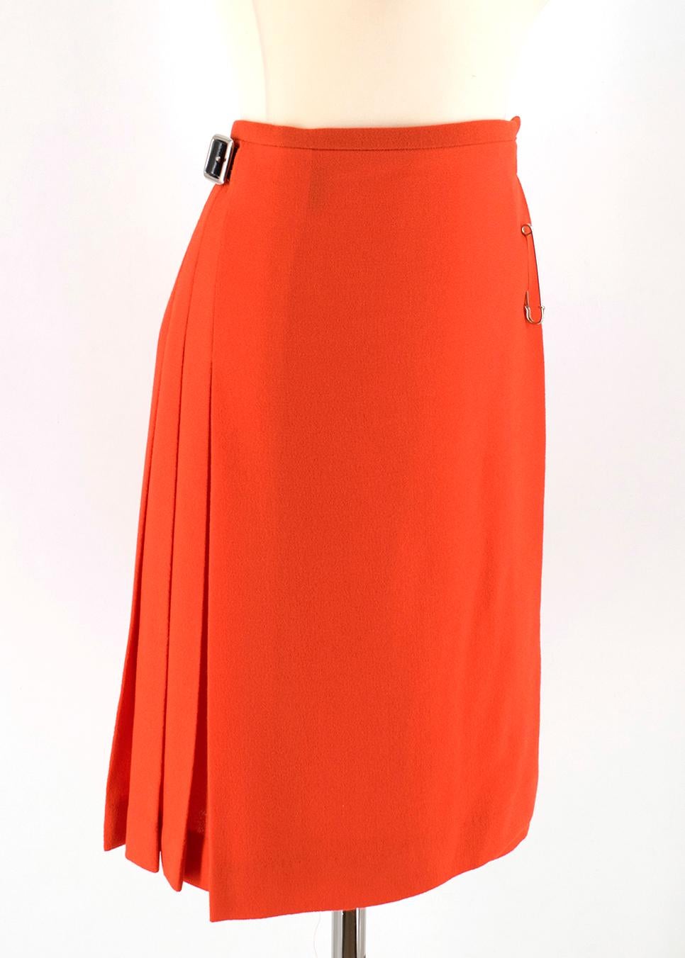 Le Kilt Orange Pleated Wool Skirt

- orange wool skirt 
- wrap style
- leather buckle fastening to the sides
- silver tone hardware
- pleated to the back
- large pin embellishment

Please note, these items are pre-owned and may show some signs of