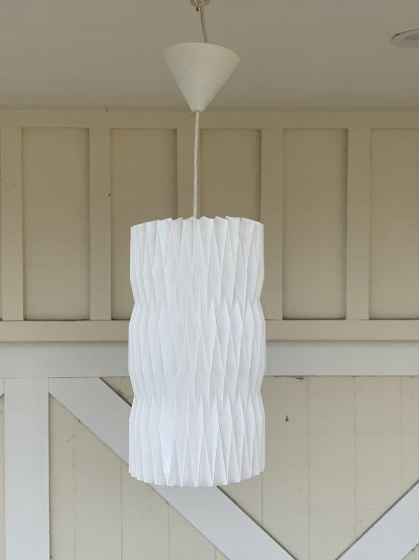 Inspired by the cross-pleating technique used in Kaare KlintÂ’s Fruit lamp, Tove and Edvard Kindt-Larsen were inspired to design this cylindrical lampshade, with three distinctive and decorative bands at the meeting of the