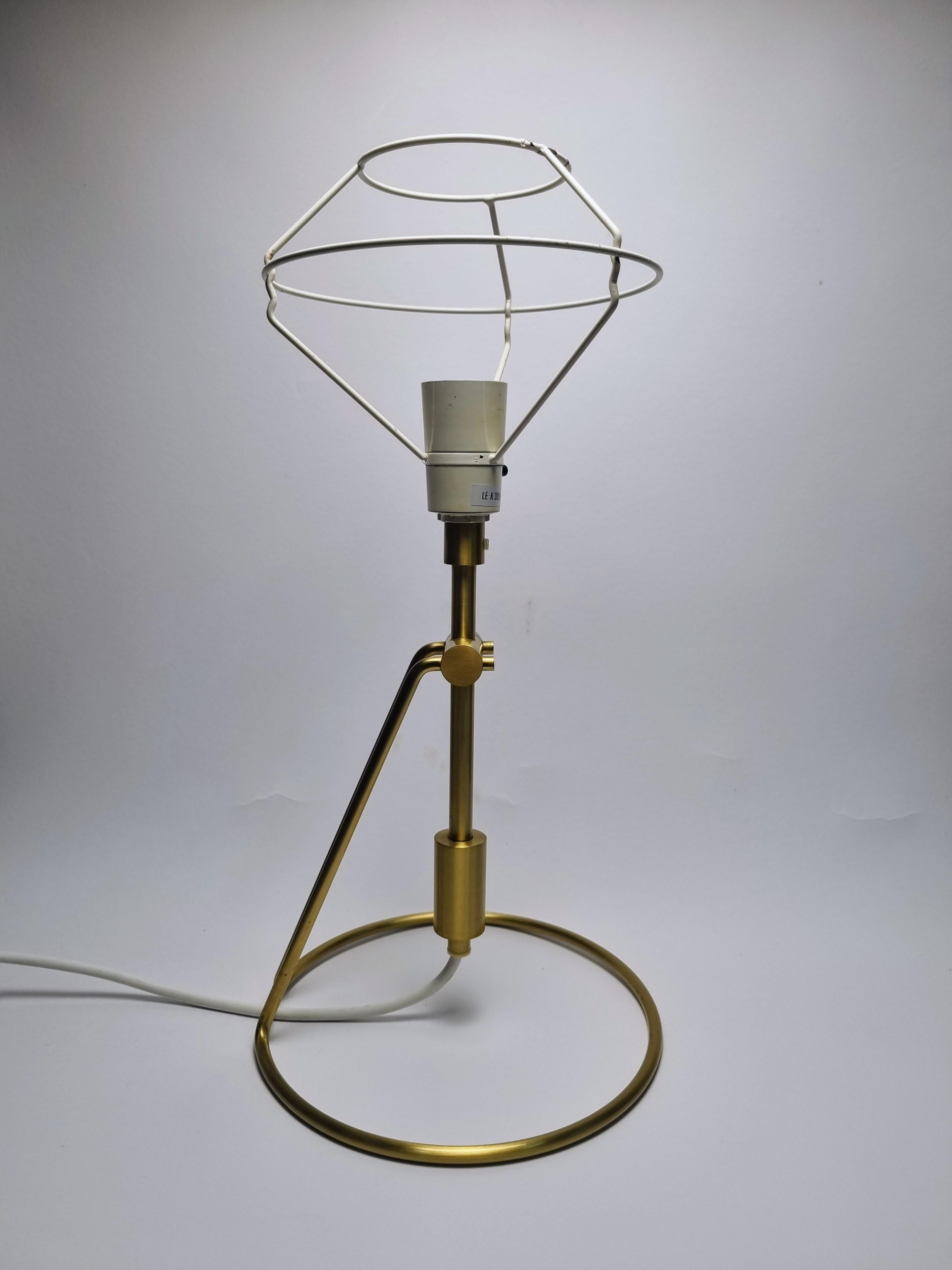 Le Klint model 305 designed by Peter white. 
This lamp can be used both as a table lamp and a wall lamp. 
It is made of brass and comes with an original le klimt lampshade holder, but without a lampshade.
Cable fitted with EU plug.