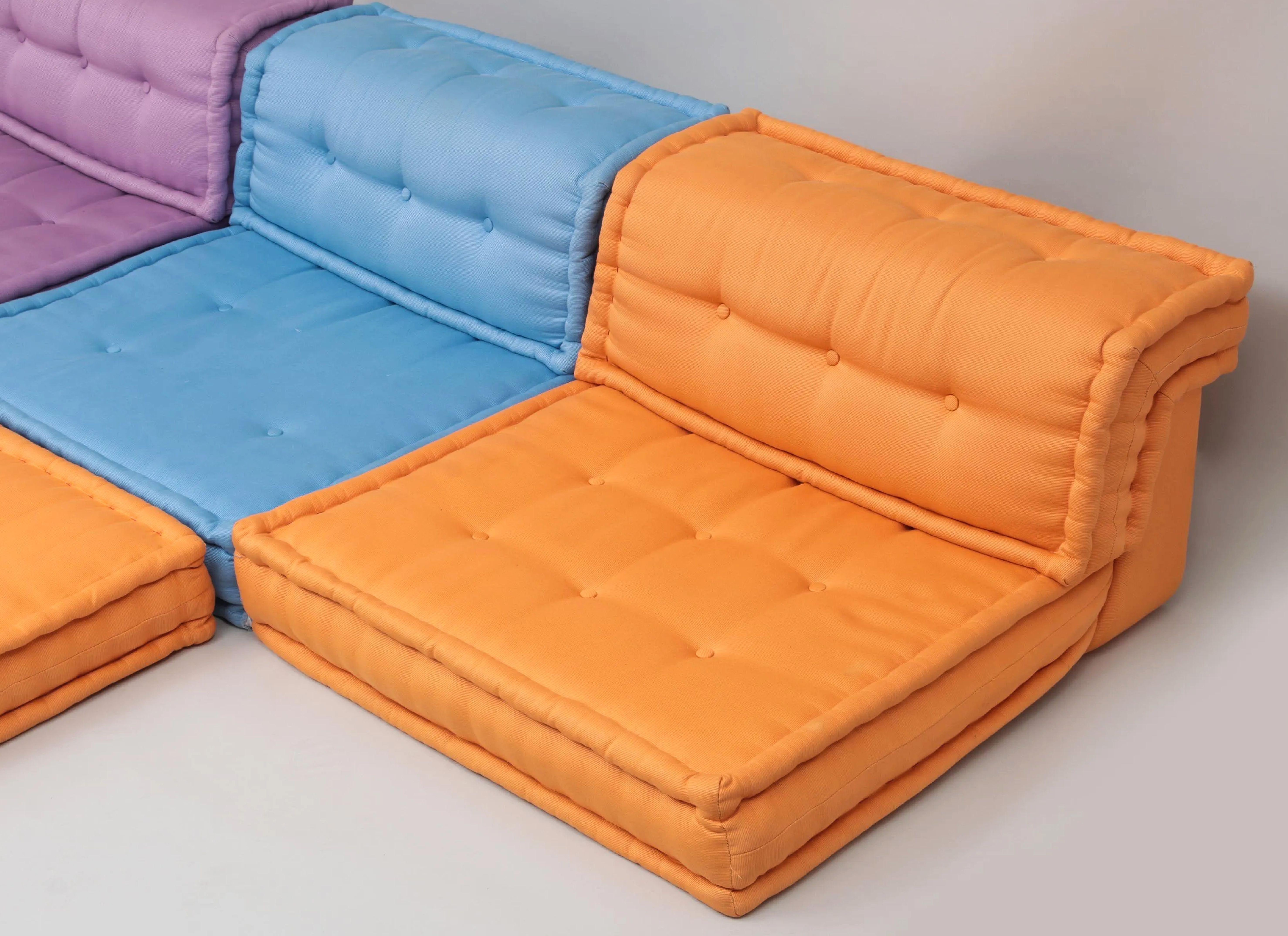 Mah-Jong modular sofa set by Hans Hopfer, designed in 1971 for Roche Bobois and a textile from the house of Missoni. This listing is for a set of elements as follows: 7 square cushions (1 Persian pink, 1 tea green, 2 orange, 1 lavender, 1