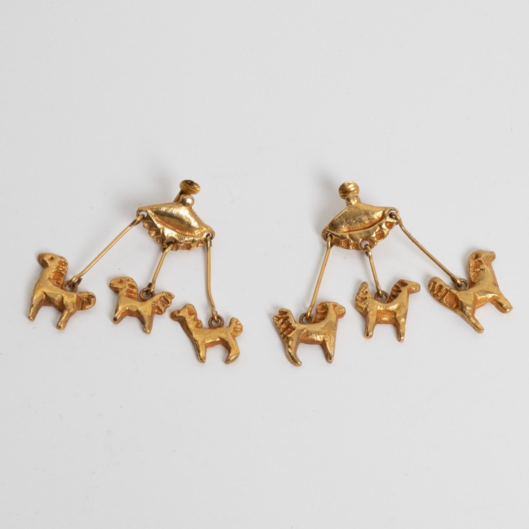 About Le Manège (The merry-go-round) by Line Vautrin
Rare pair of gilt bronze earrings.
Each earring representing a merry-go-round on which three horses are suspended.
Each earring signed LV.