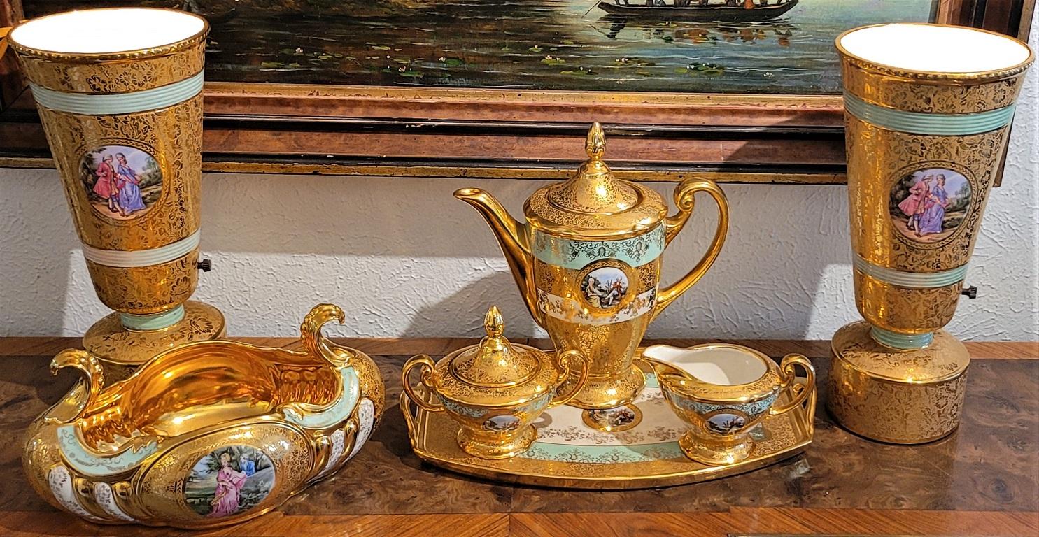 Presenting a stunning Le Mieux 7 Piece 24kt gold Porcelain set.

Marked for “Le Mieux China …. 24karat gold … hand decorated”

The Set consists of a pair of vase shaped uplighter table lamps, a serving tray, a teapot, sugar pot and creamer and a