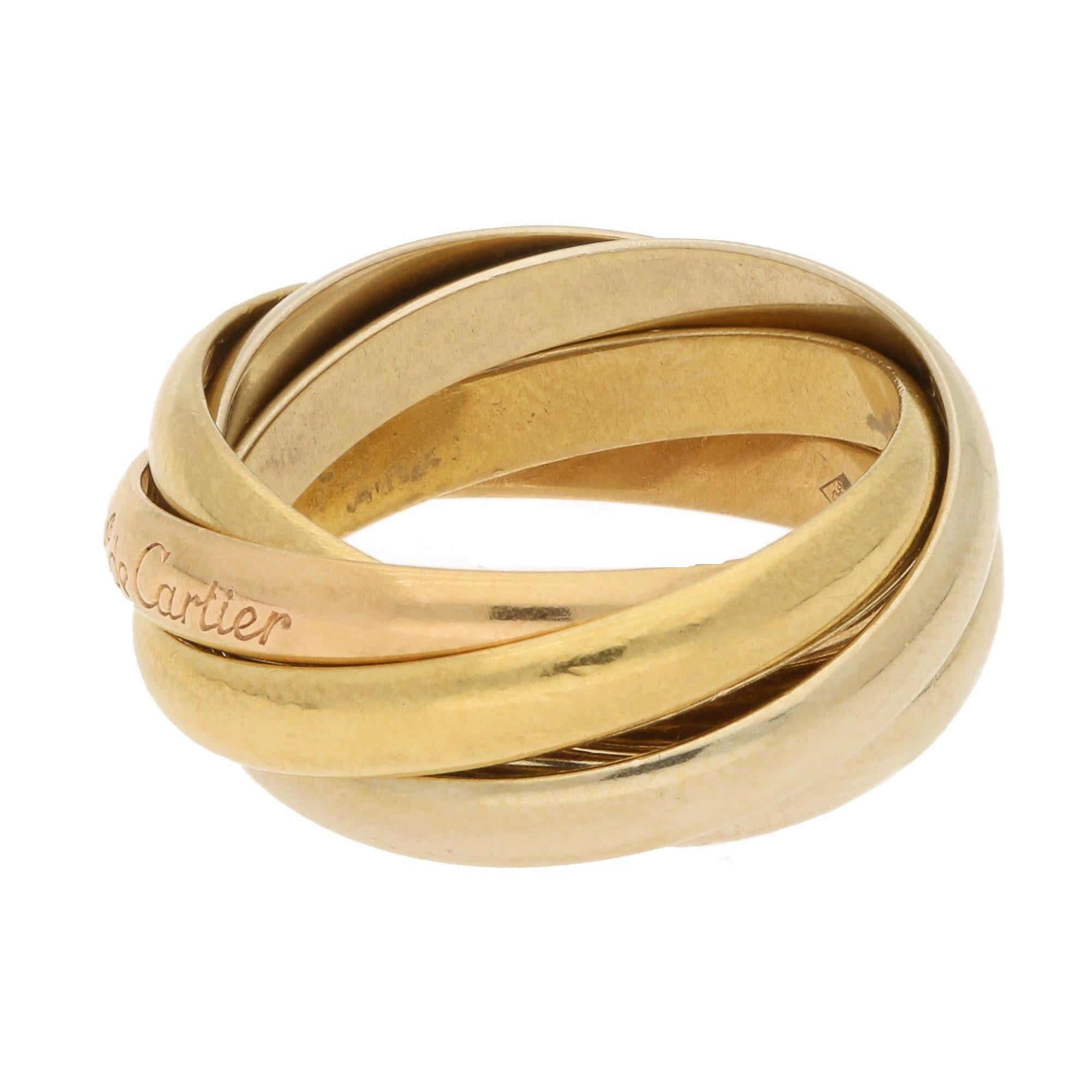 A classic from Cartier, this Les Must de Cartier 5-band ring in 18-karat gold is composed of 2 yellow bands, 2 white bands, and 1 rose band, the latter one engraved with “les must de Cartier” on the outside. 
This ring is a finger size H ½ (Cartier