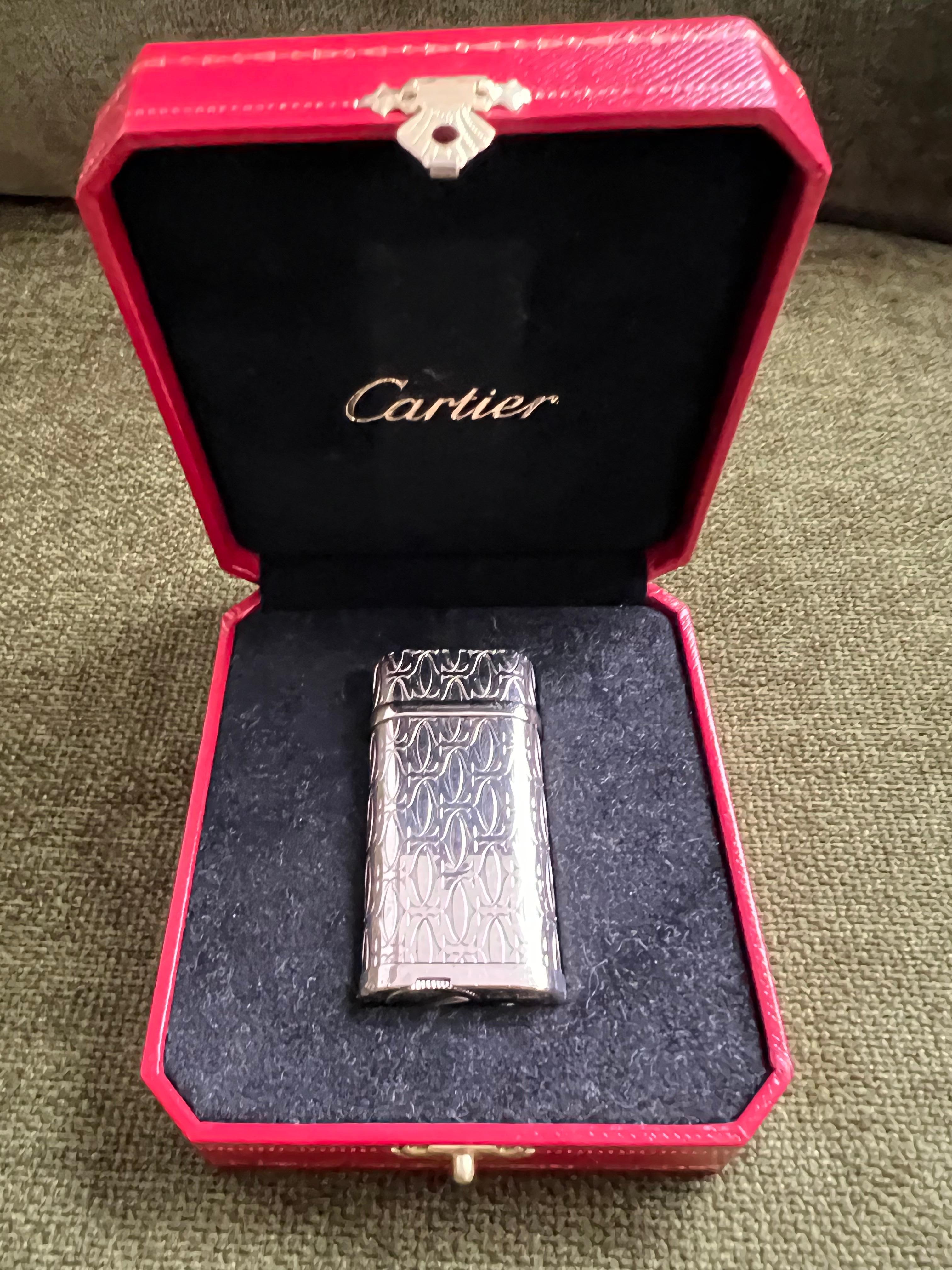 Cartier Lighter C de Cartier Silver and Palladium Finish 
Comes with original Cartier case 
In mint exterior and working condition 
Circa 2000
In great condition 
The lighter ignites, sparks and flames