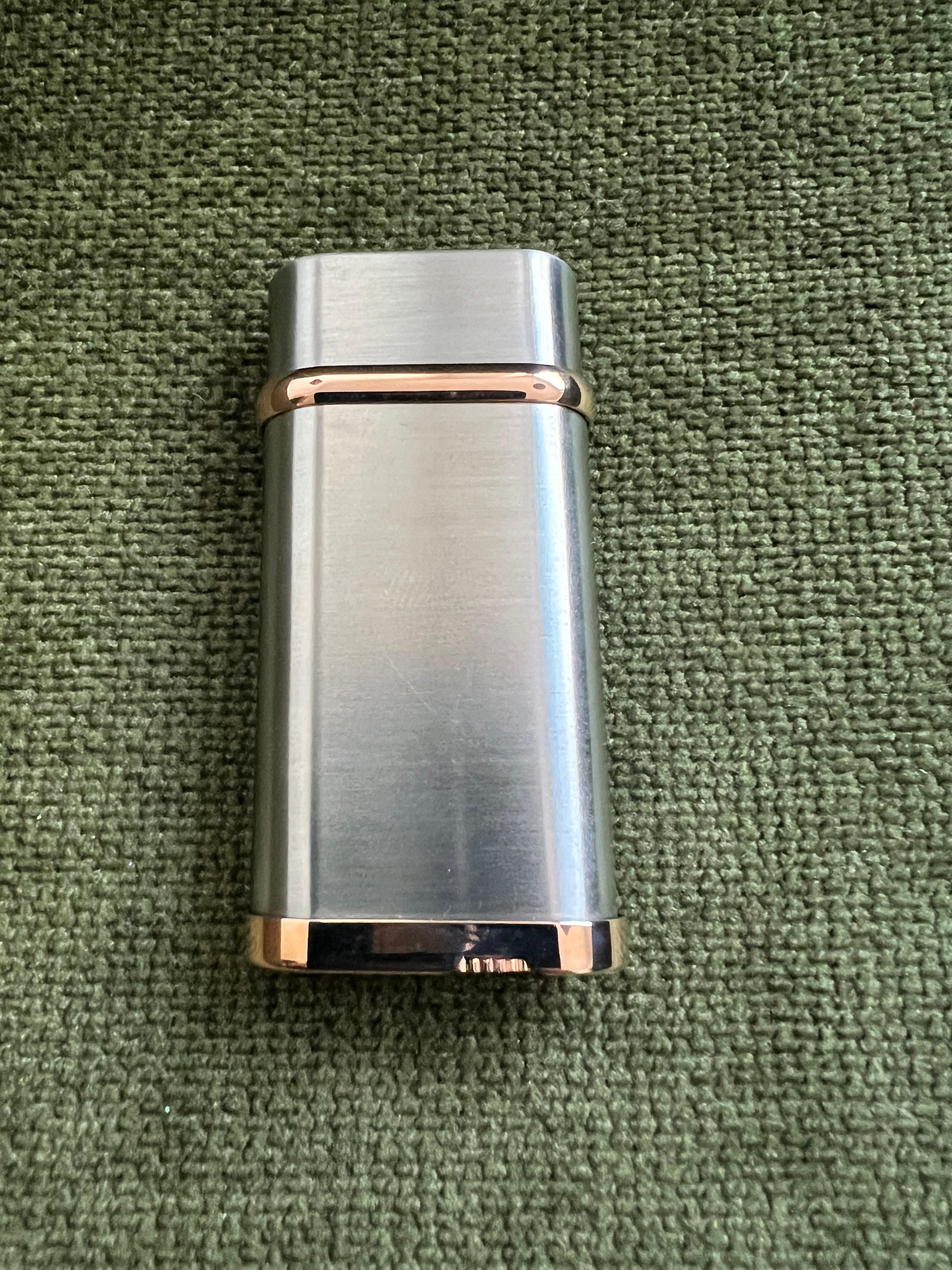 Le Must De Cartier Logo Gold & Palladium Lighter In Original Cartier Case

Cartier Lighter Palladium Finish with 18K Gold plating 
