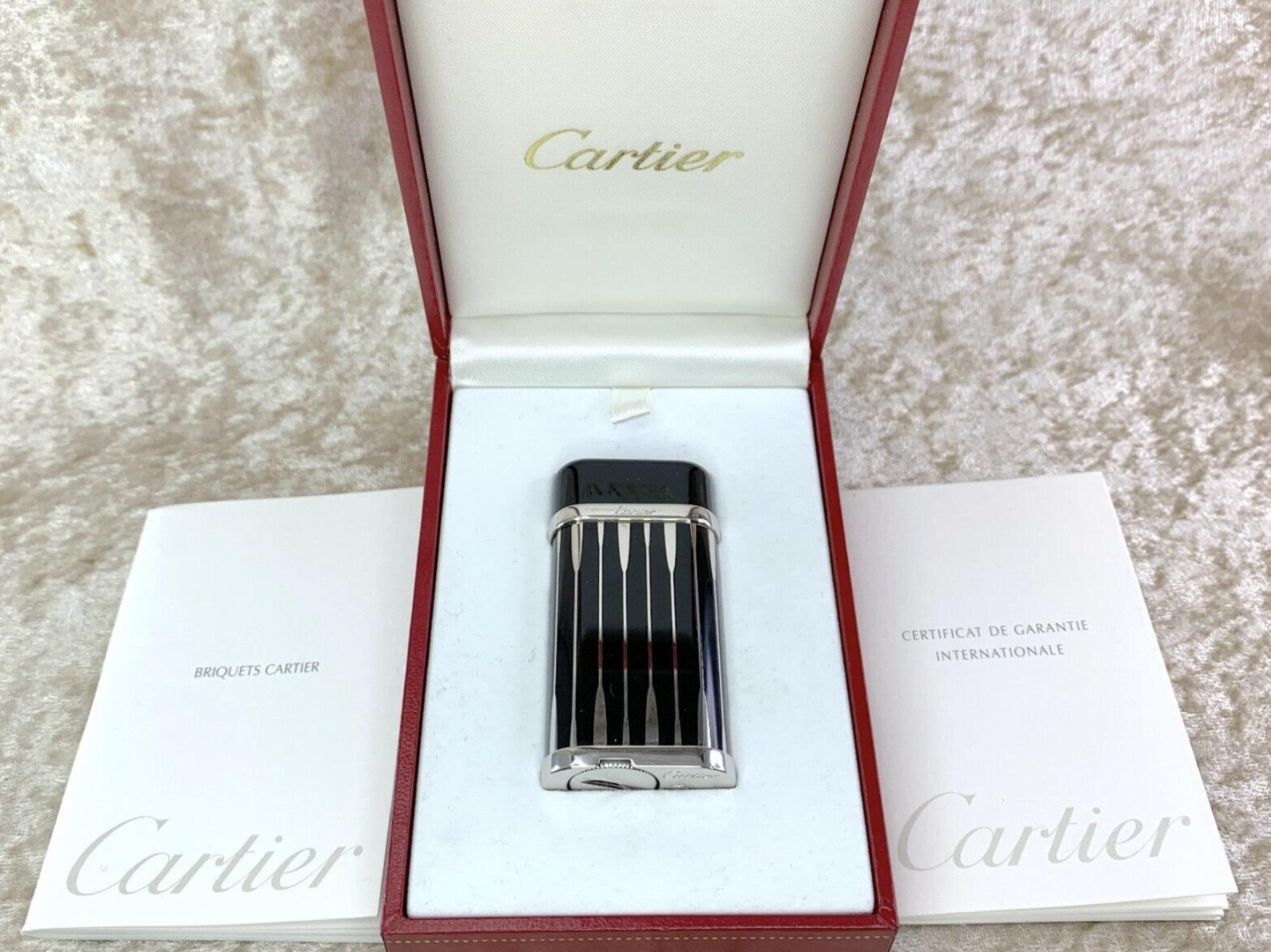 Cartier Lighter - Very Rare Backgammon 
Black and Silver
Original Cartier Case and Cartier Certificate
Oval shape 
60 x 30 x 12 mm
Year - 2011
The lighter is in excellent condition
Has all original parts 
Ignites, sparks and flames 

