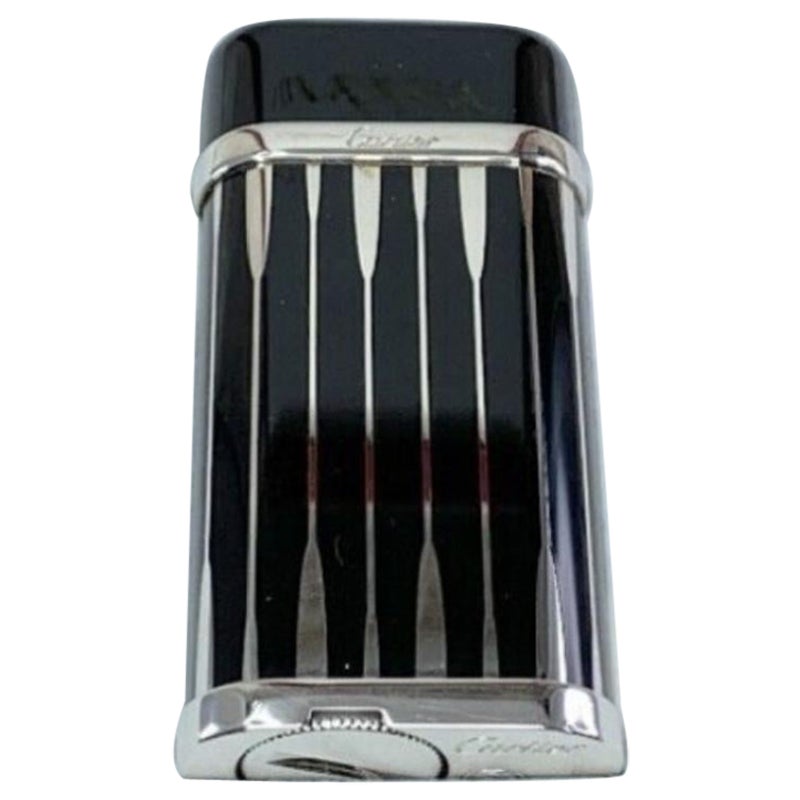 “Le Must de Cartier” Very Rare Backgammon Black & Silver Lighter With Case 
Cartier Lighter - Very Rare Backgammon 
Black and Silver
In Original Cartier Case 
With Original Cartier Certificate
With original Cartier papers 
Oval shape 
60 x 30 x 12