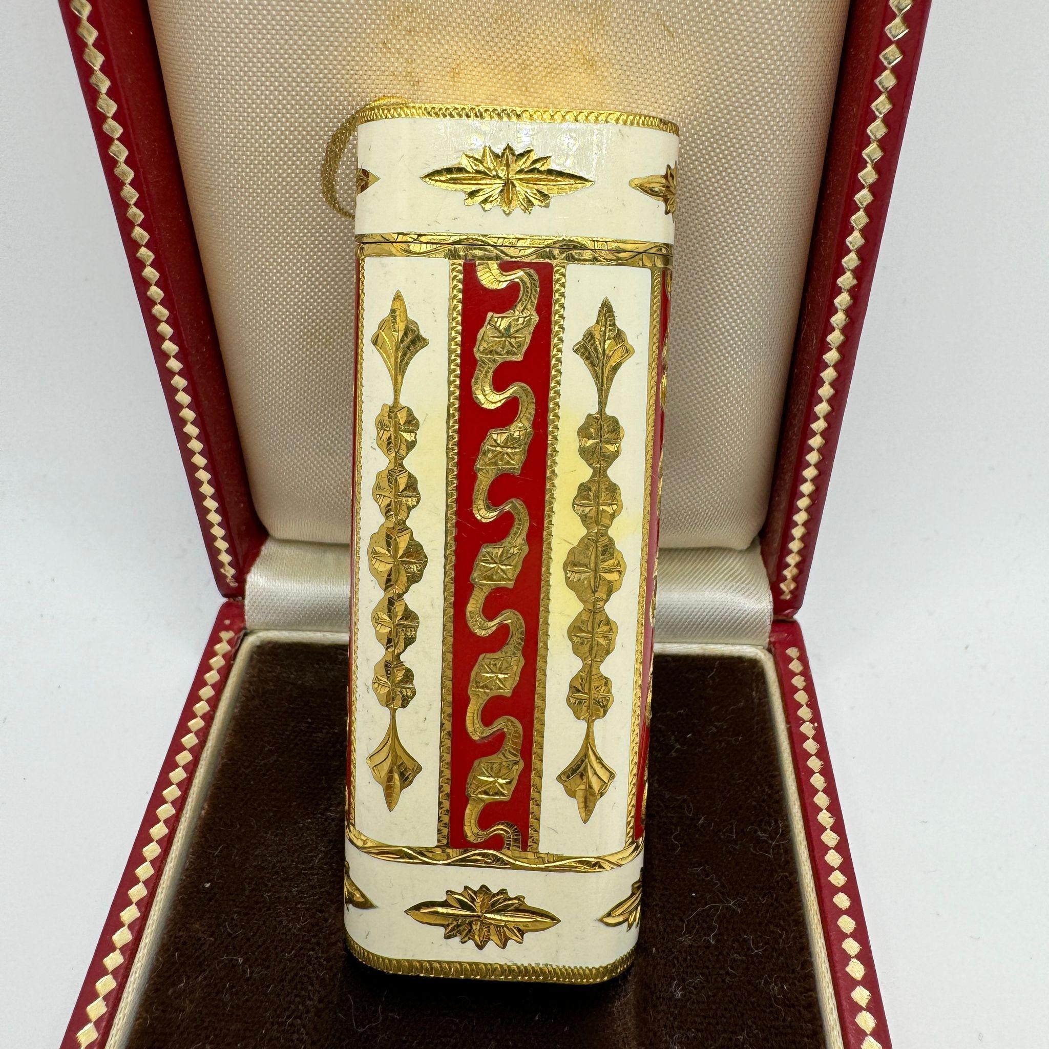 Le Must de Cartier Very Rare Royking Lighter, 18k Gold Plating & Enamel Inlay 
Cream and red color 
Cartier “Royking” lighter.
Circe 1970
CARTIER  Roy King Rollagas, a Unique RARE example of a ROYKING designed Cartier Rollagas lighter made circa