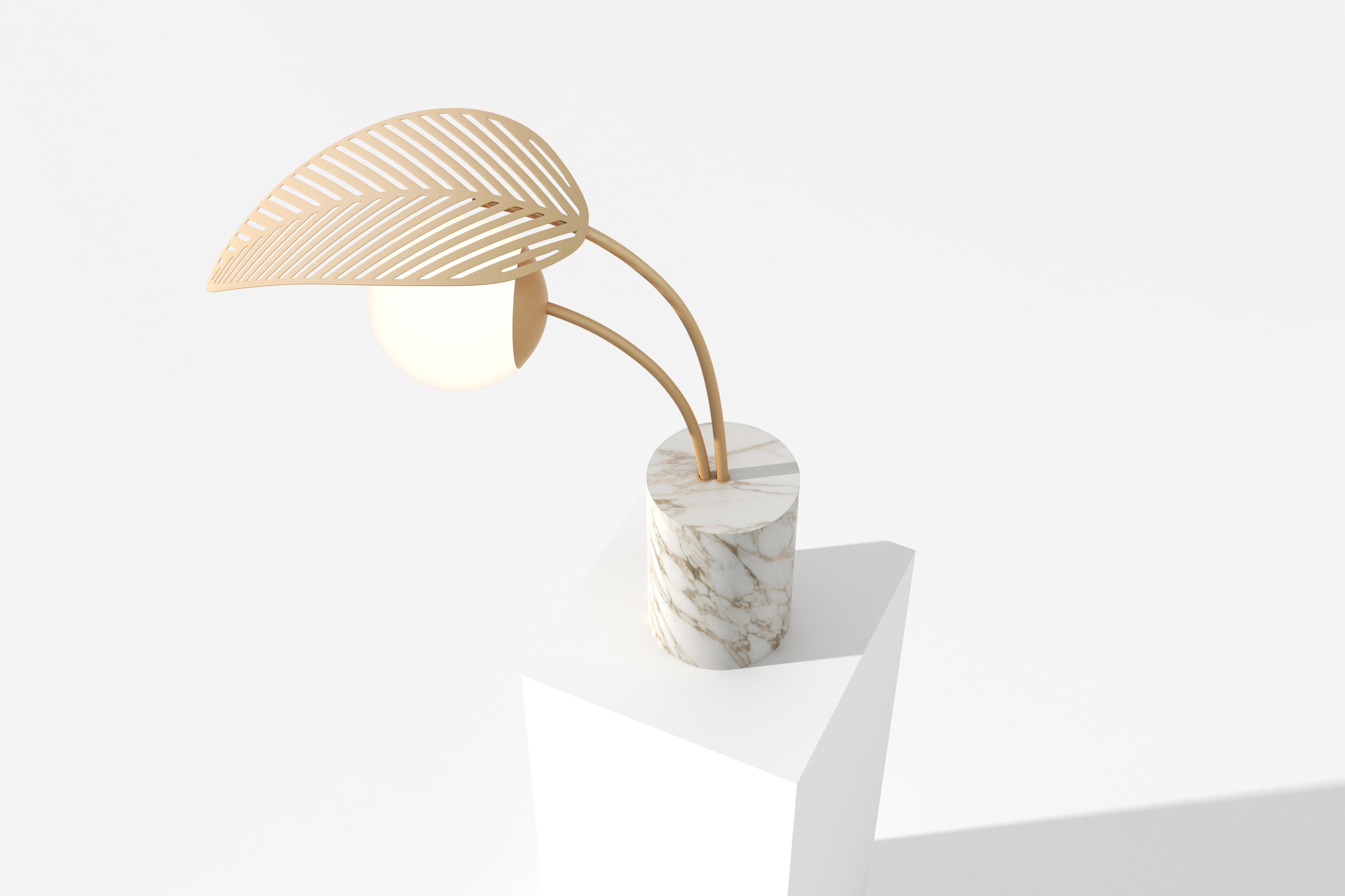 Floor lamp with Calacatta marble base, sheltered by one palm leaf, die-cut in gold metal.
Frosted lamp shade and dimmable light.

Designed by Parisian-Italian artist Marc Ange, who’s creations are always balanced between real and unreal,