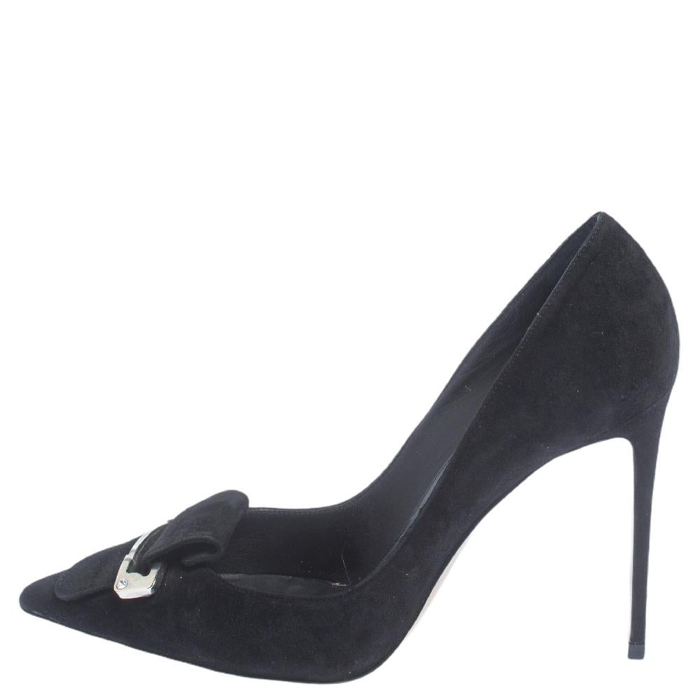 Simple, elegant, and comfortable, these Le Silla pumps will make a fine addition to your shoe collection. They are constructed using black suede, detailed with a buckle on the pointed toes, lined with leather, and lifted on 10.5 cm heels.

