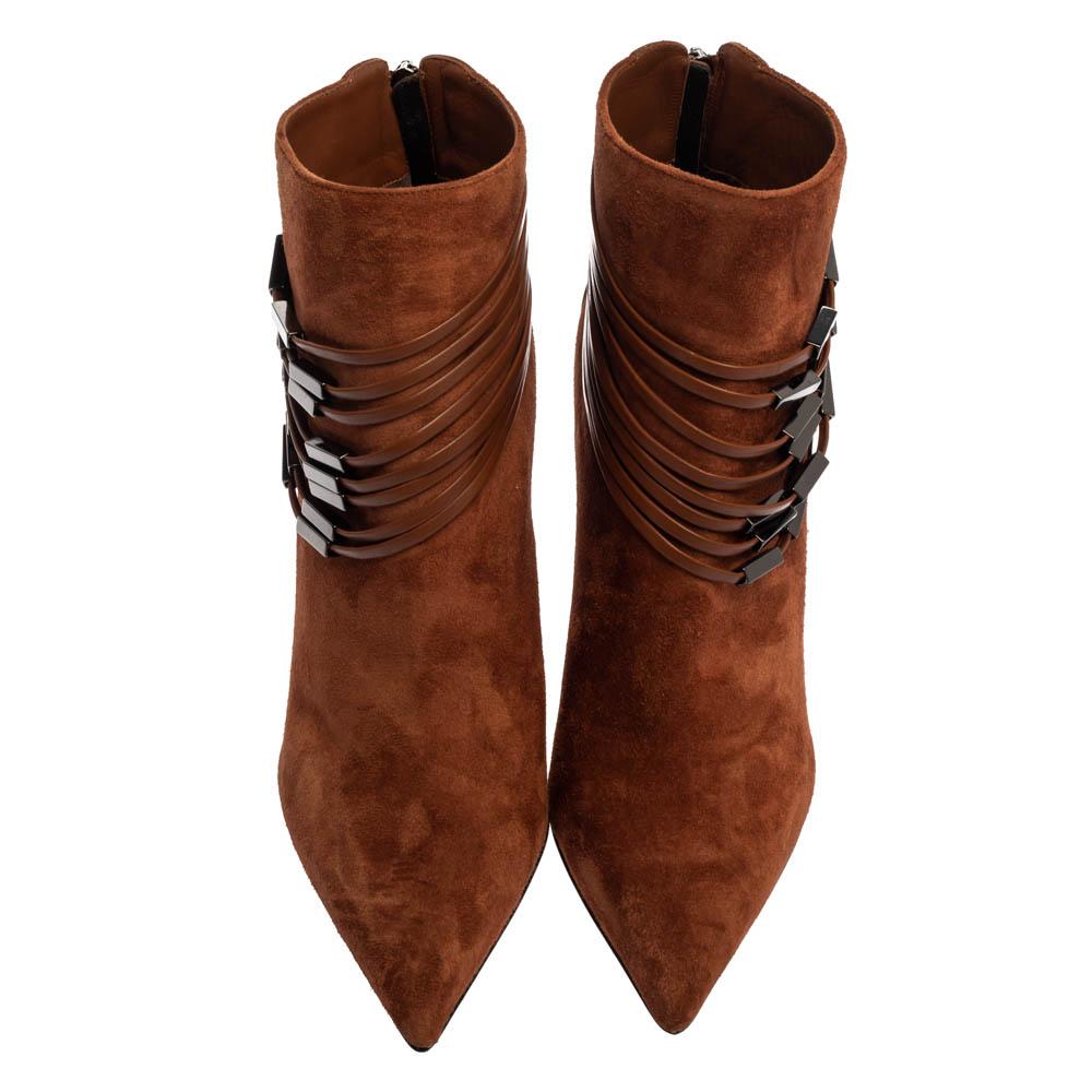 How stylish are these ankle booties from Le Silla! These brown boots have been crafted from suede and styled with embellished strap details, pointed toes, and back zippers. They are elevated on 10 cm stiletto heels.

Includes: Original Dustbag,