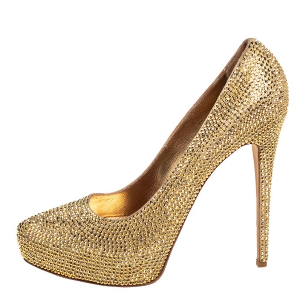 An exclusively designed pair for you to help you make a statement! These Le Silla platform pumps are crafted from gold suede and styled with pointed toes. They are decorated with crystal embellishments all over and come equipped with comfortable