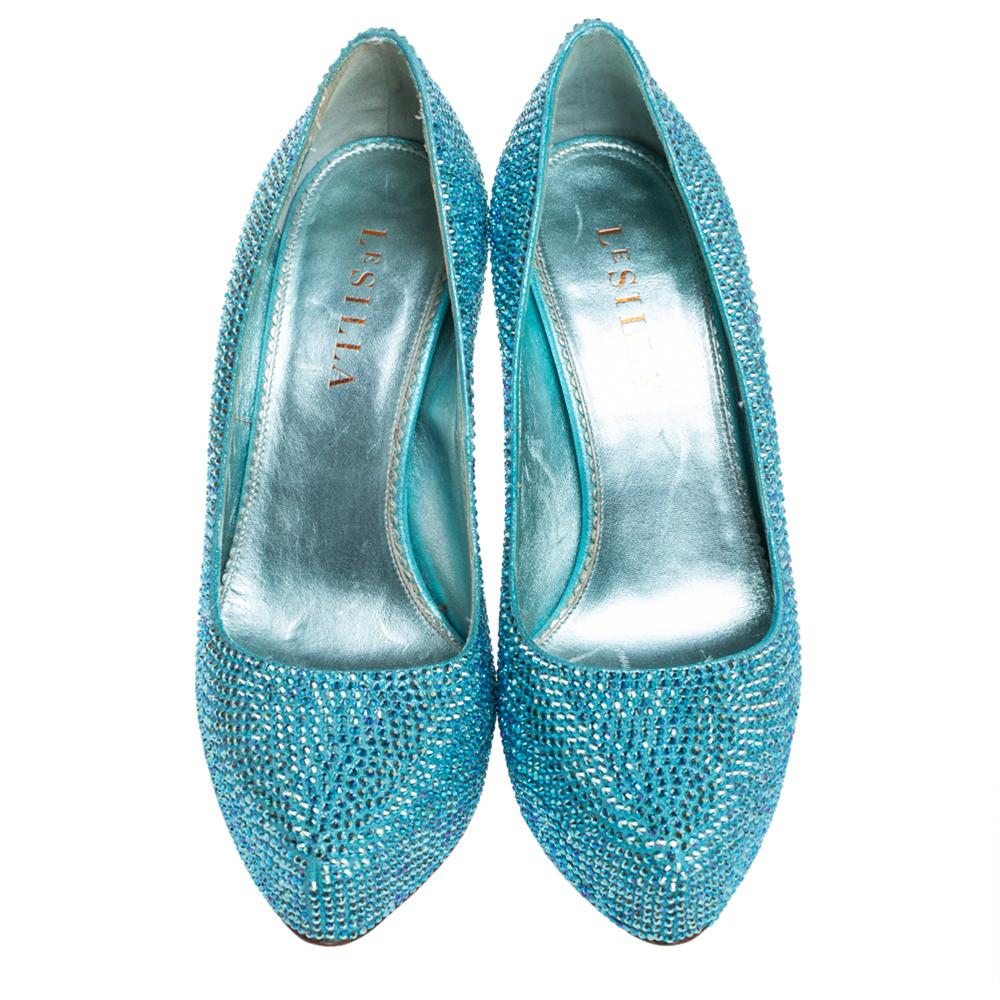 An exclusively designed pair for you to help you make a statement! These Le Silla platform pumps are crafted from metallic blue leather and styled with almond toes. They are decorated with crystal embellishments all over and come equipped with