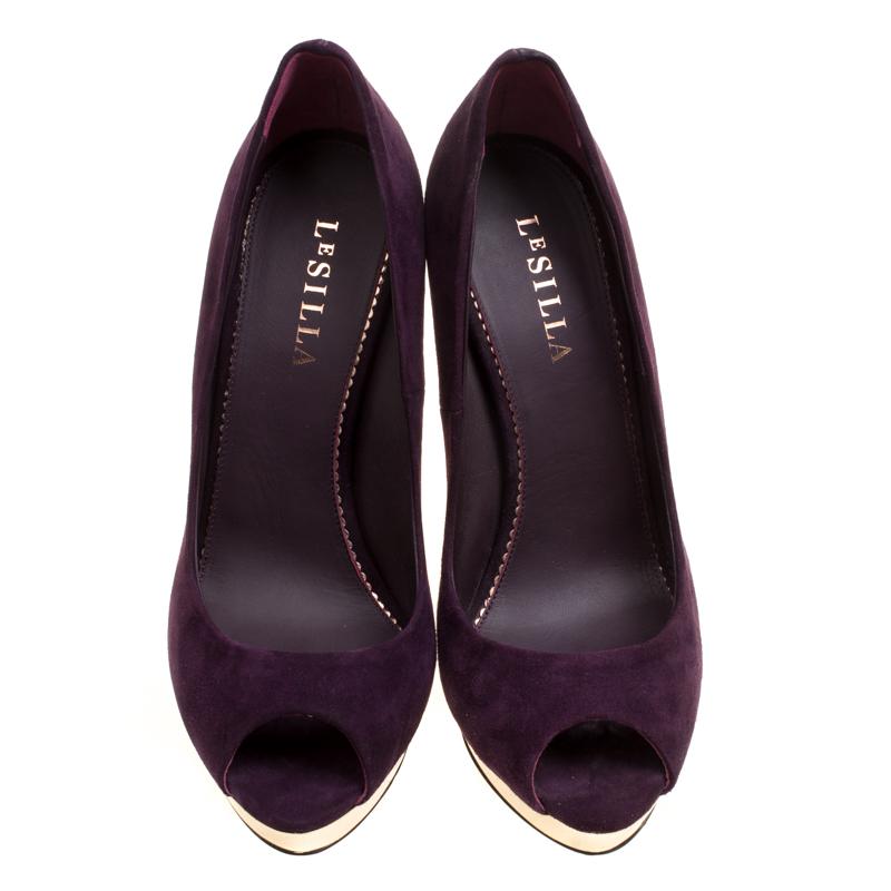 This creation by Le Silla never goes out of style! Beautifully crafted from suede in wine purple it has metal on the platforms. The pumps carry a peep toe style with leather insoles and stiletto heels. They will perfectly complement all your dresses