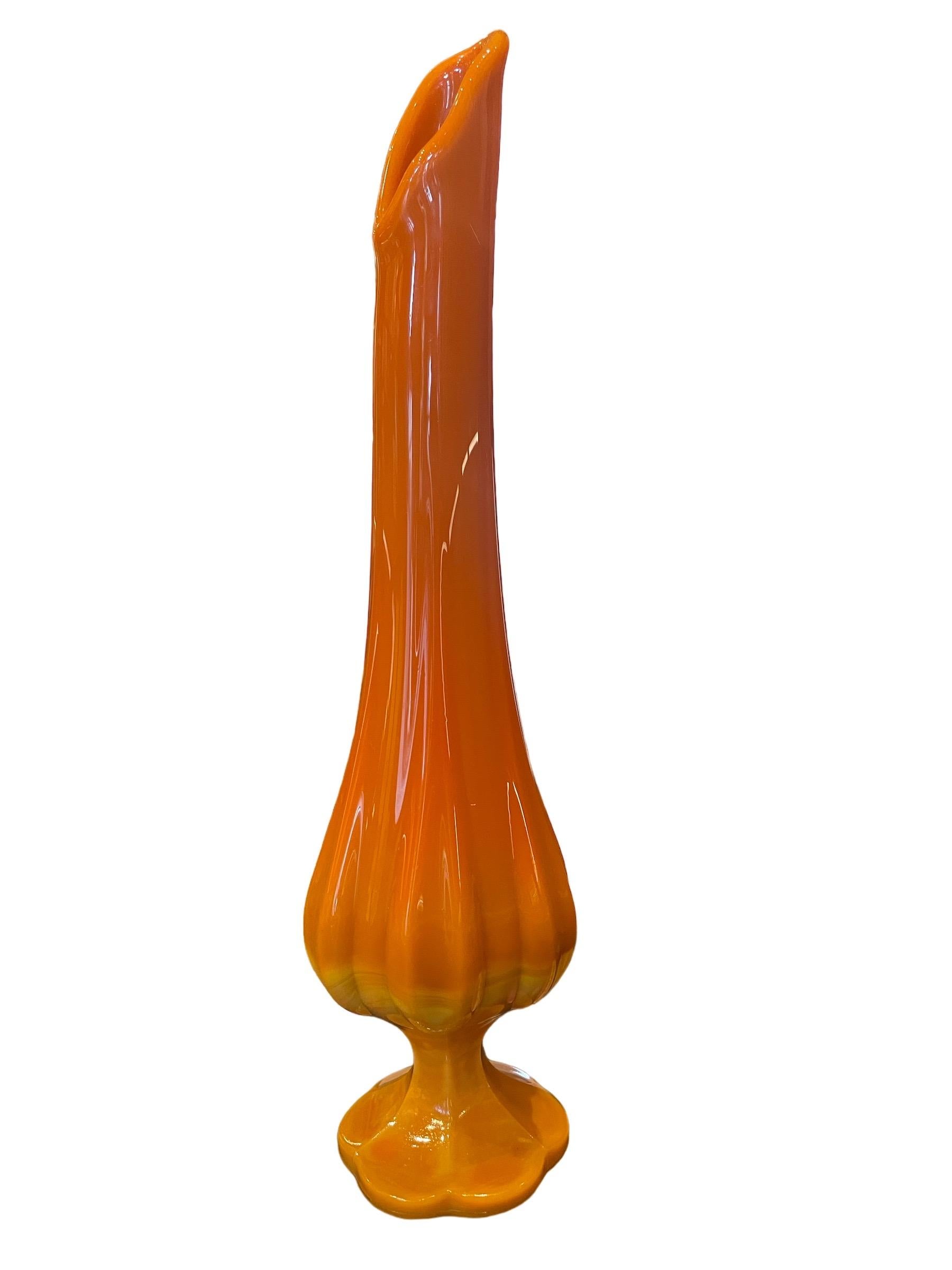 LE Smith Vintage Swung Bittersweet Orange Vase  

Beautiful glass pedestal vase by LE Smith circa 1960s. 15 inches tall with 6 petal design. 