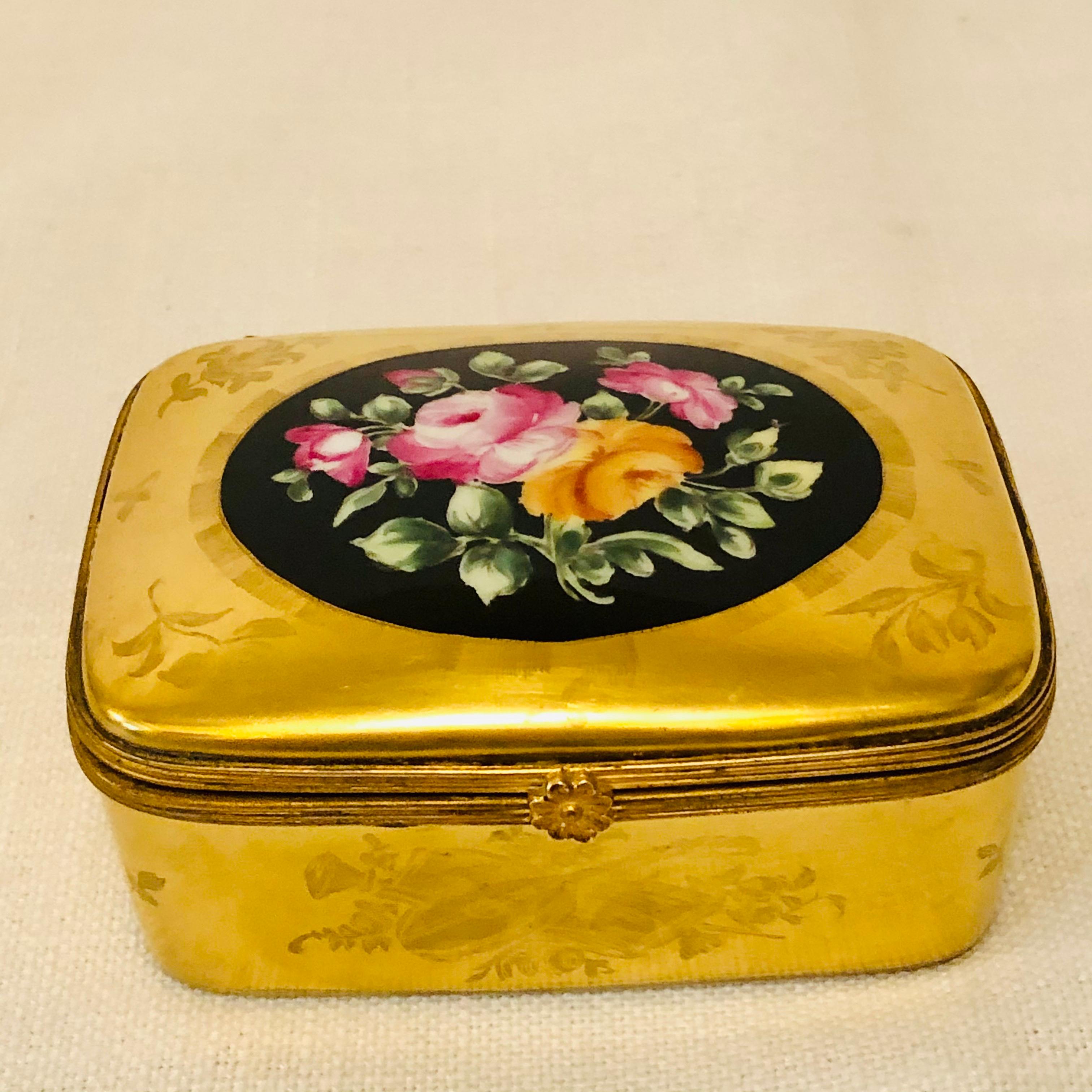 I want to offer you this fabulous Le Tallec porcelain box with a gold background. The gold background is painted with gold flowers and French emblems, like the one on the front depicting music. In the center top of the box is a lovely colorful