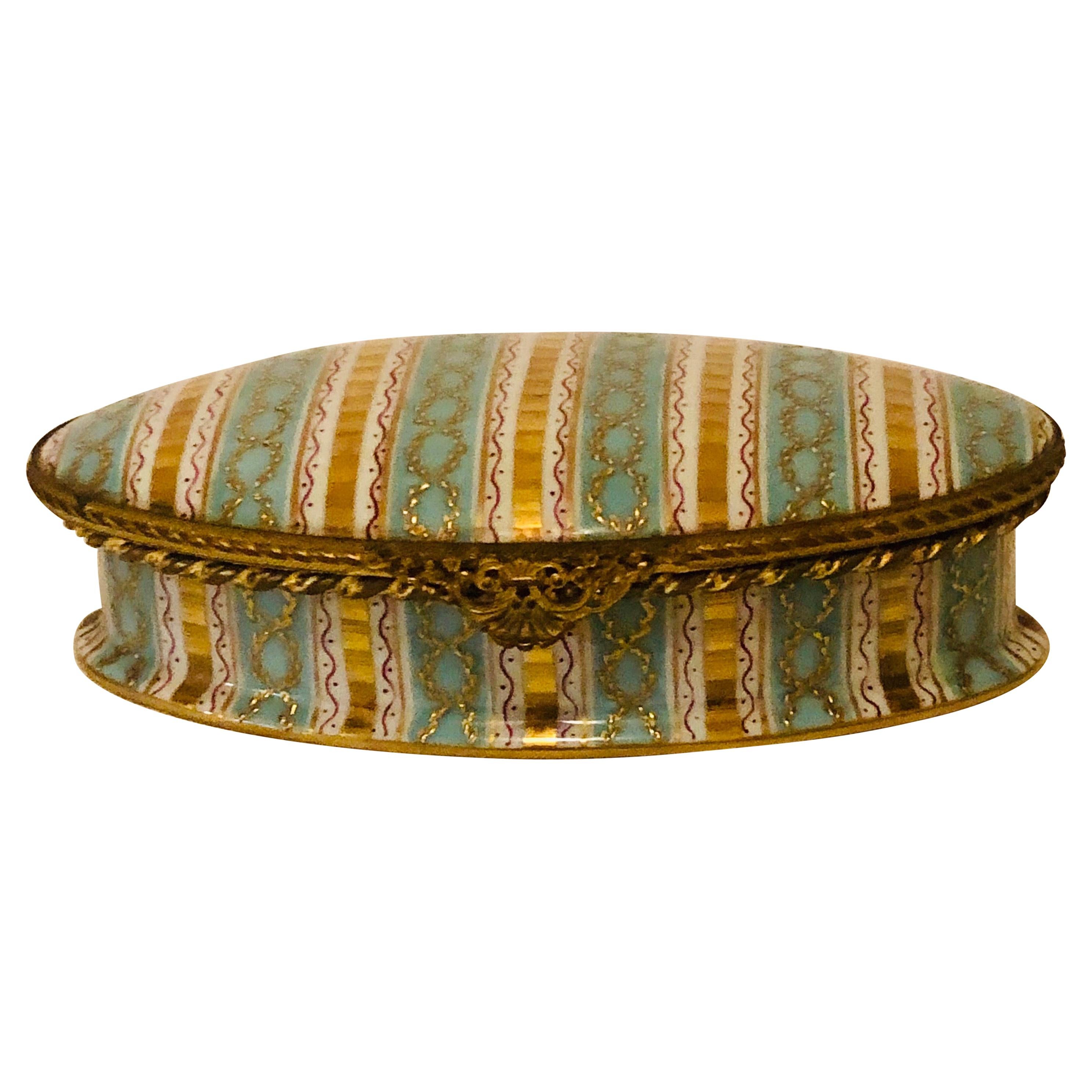 Boîte Le Tallec à rayures aqua et or et décoration circulaire en relief