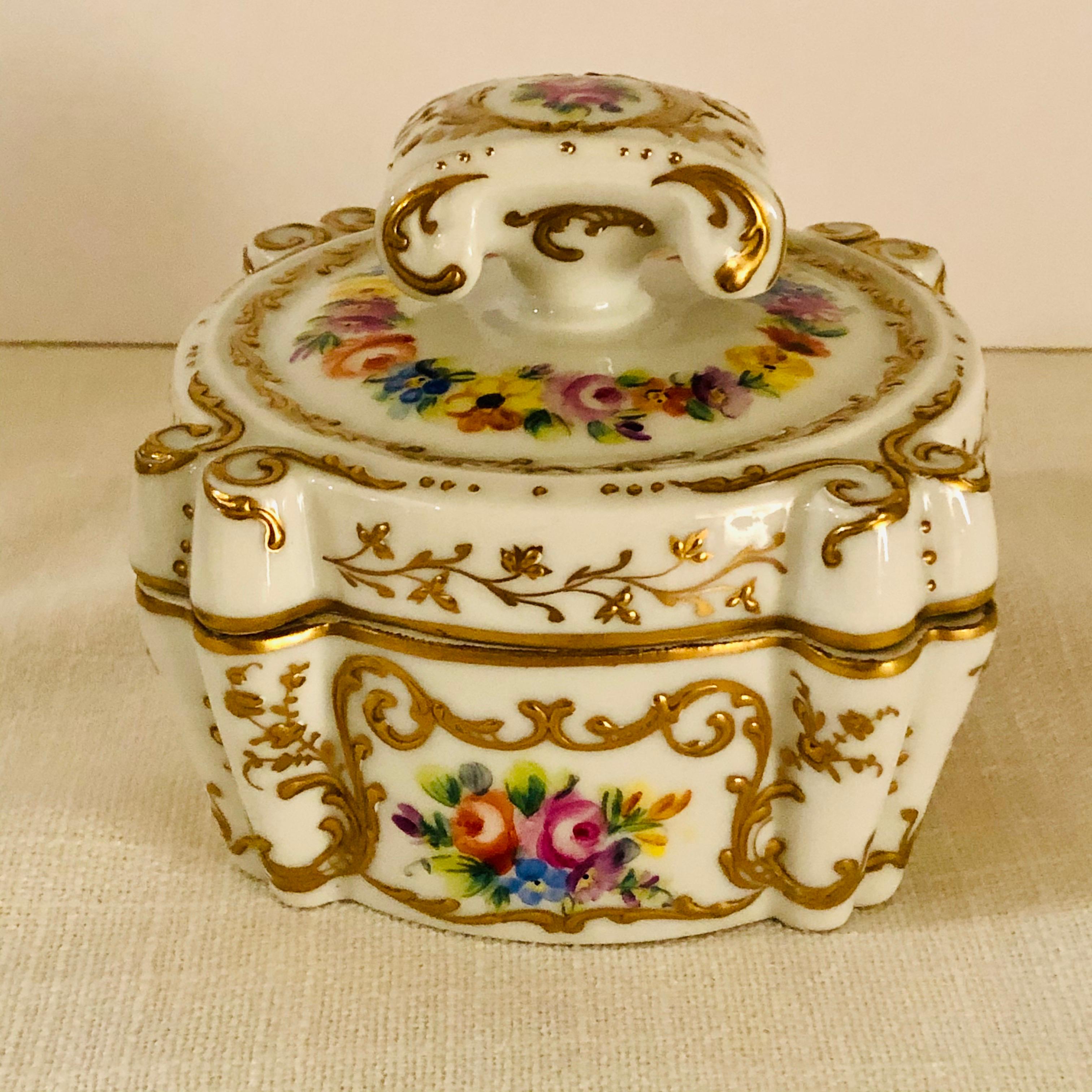 This is an exquisite Le Tallec dresser or jewelry box. It is decorated with four flower bouquets and is embellished with a filigree of raised gilding on all its sides and its top. On the top of this box, is a raised handle surrounded by a ribbon of