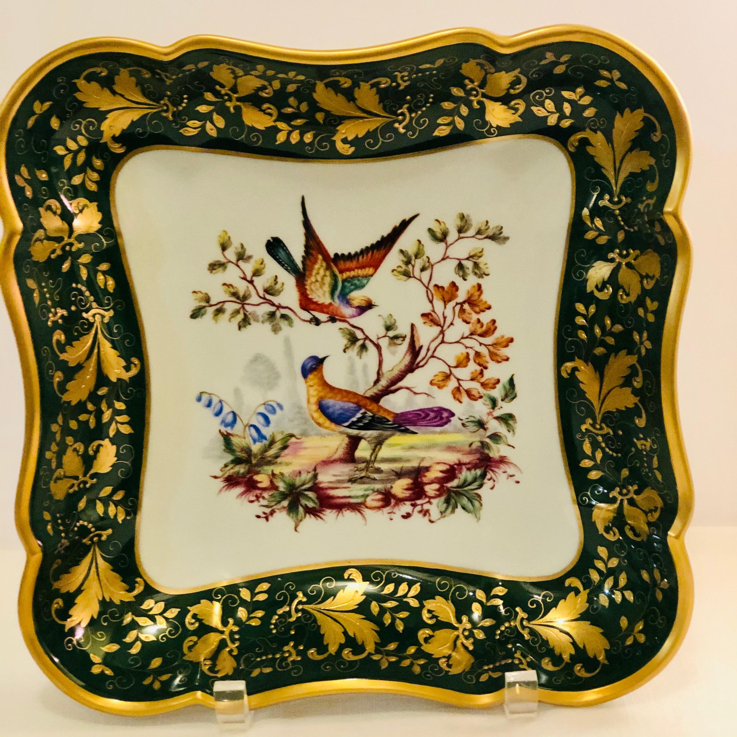 This is a fabulous Le Tallec bowl hand-painted beautifully with two colorful birds in their natural habitat. The emerald green border is embellished with raised gilded leaves and gilded jewels. This bowl would be a stunning eye catching addition to