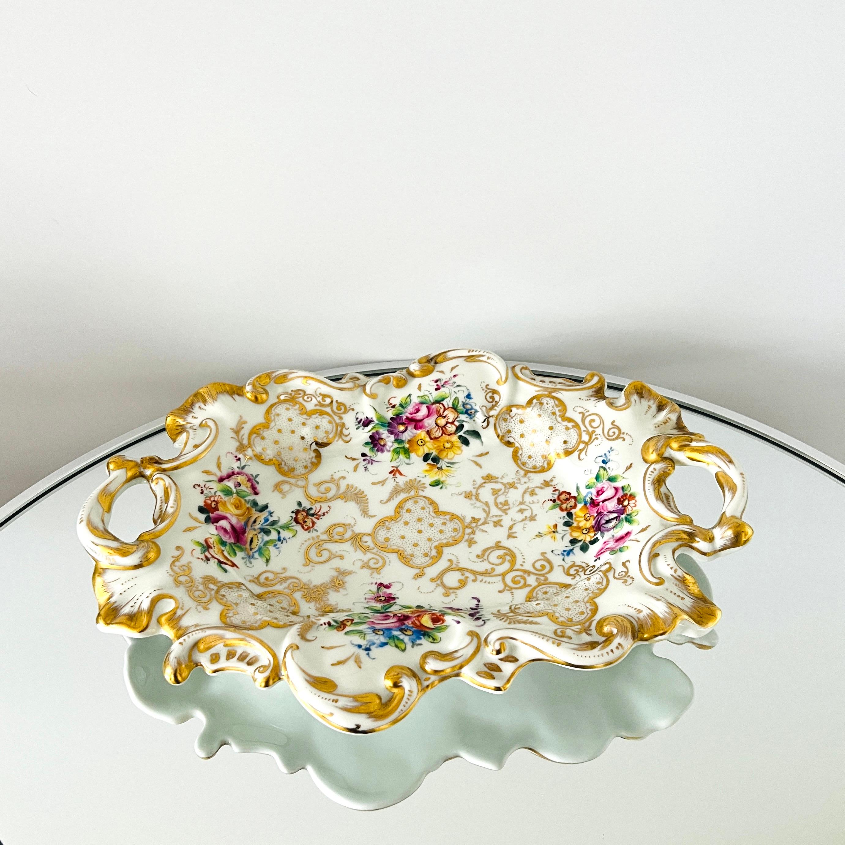 Fine porcelain tray with handles by Camille Le Tallec, Paris. The Rococo style platter features scrolled edges and has hand painted motifs in 24K Gold Leaf with colorful floral bouquets. Makes an elegant serving tray for entertaining and is perfect