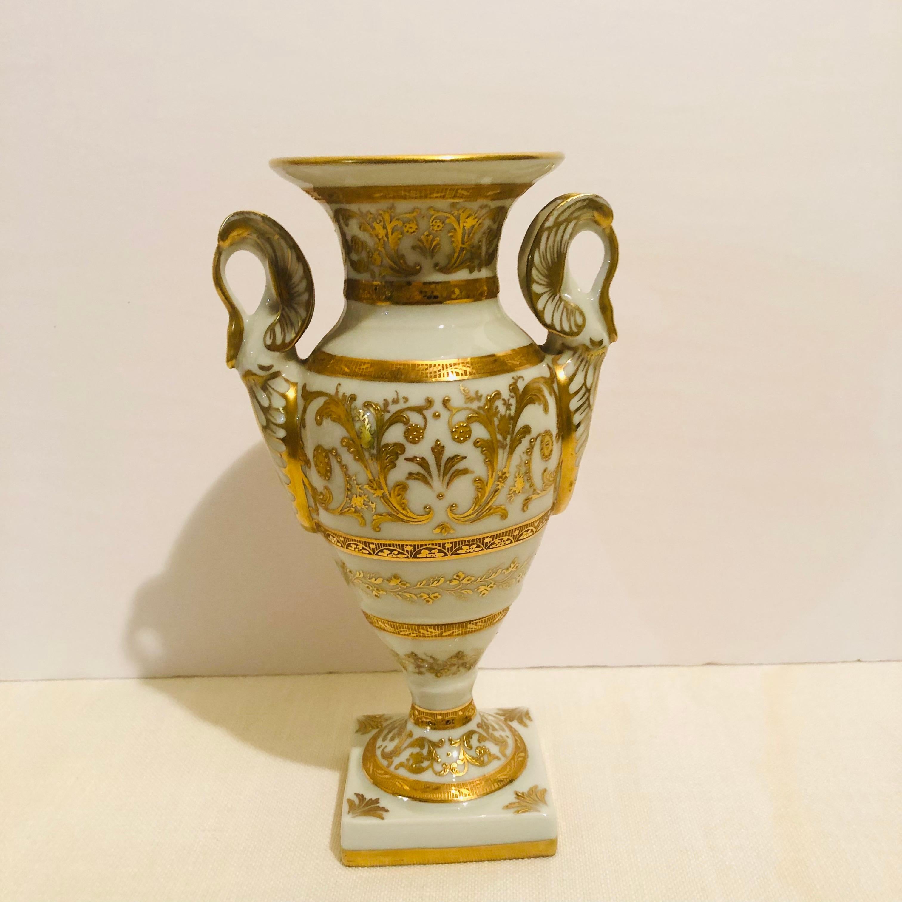   This is an exquisite Le Tallec vase with elaborate raised gilding on a white ground. The vase has neoclassical type handles that look like swan heads. It would be a gorgeous accent piece for your mantle, on a table or for your dining room table.