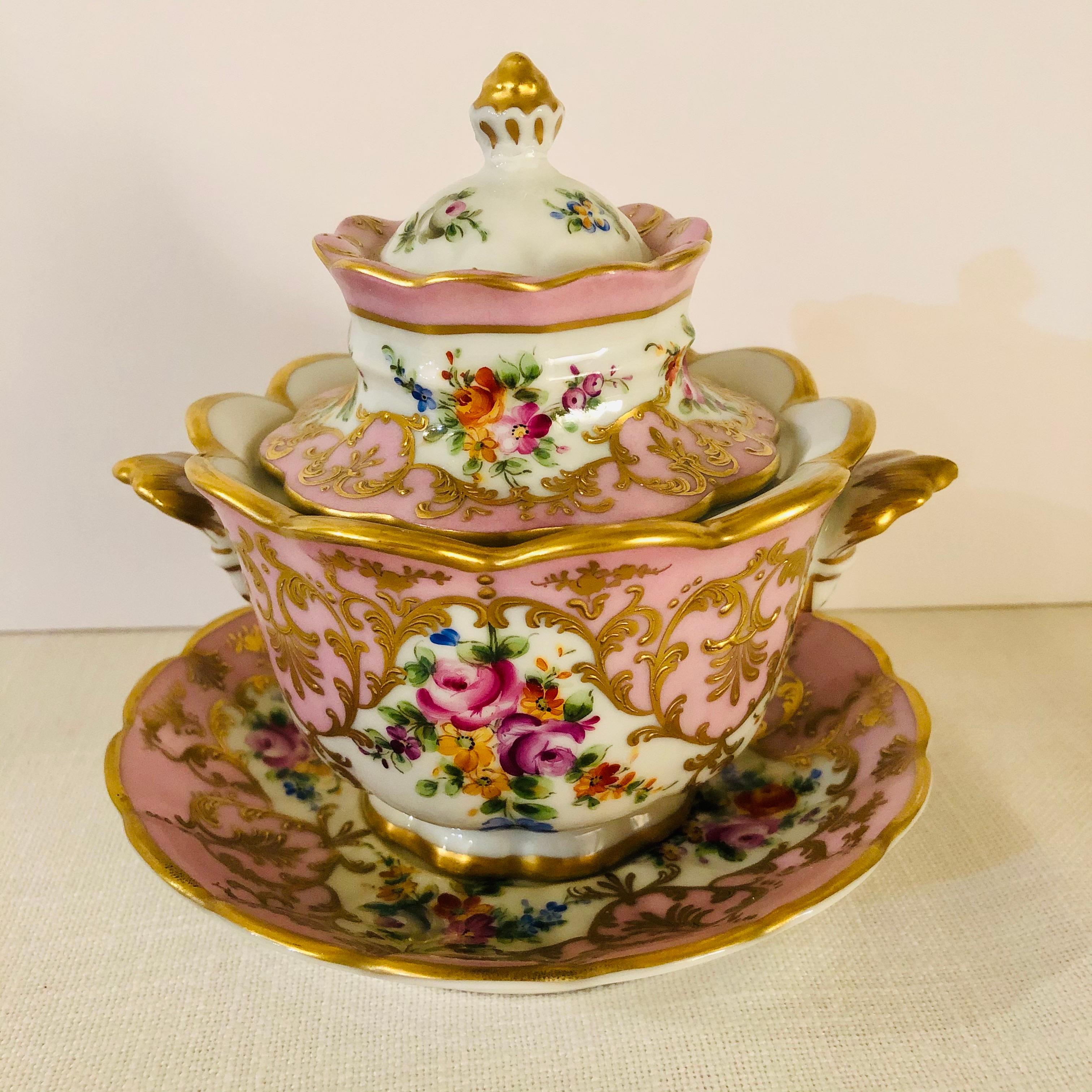 I want to offer you this stunning pink Le Tallec covered bowl with underplate. It has hand-painted flower bouquets on both sides. It has a flower shaped cover. The three pieces are embellished with perfuse raised gilding. It has a pink pompadour