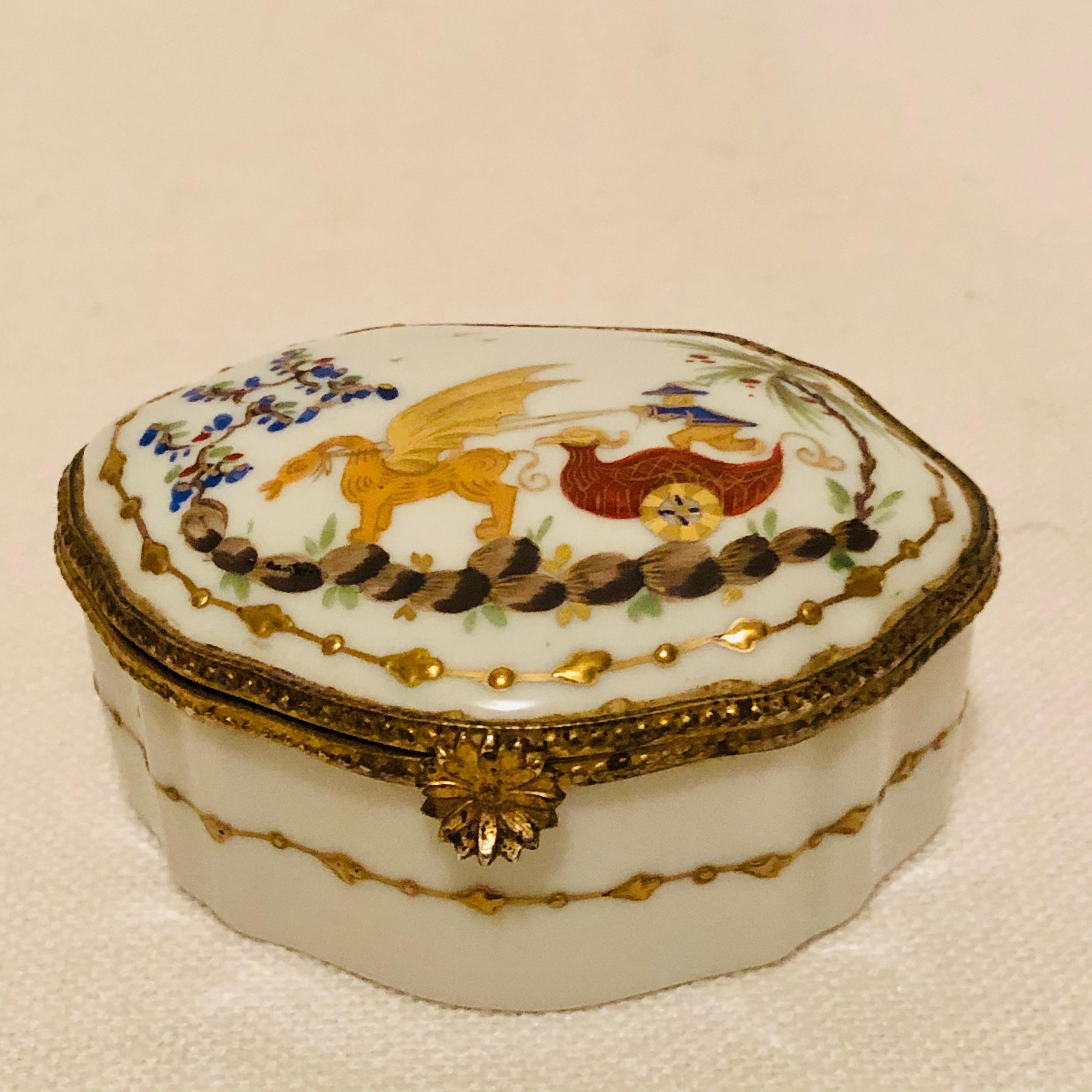 This is a wonderful Le Tallec porcelain box hand-painted with a whimsical chinoiserie scene surrounded by raised gold accents. This would be an enchanting addition to any porcelain box collector or any collector of Le Tallec porcelain pieces. This