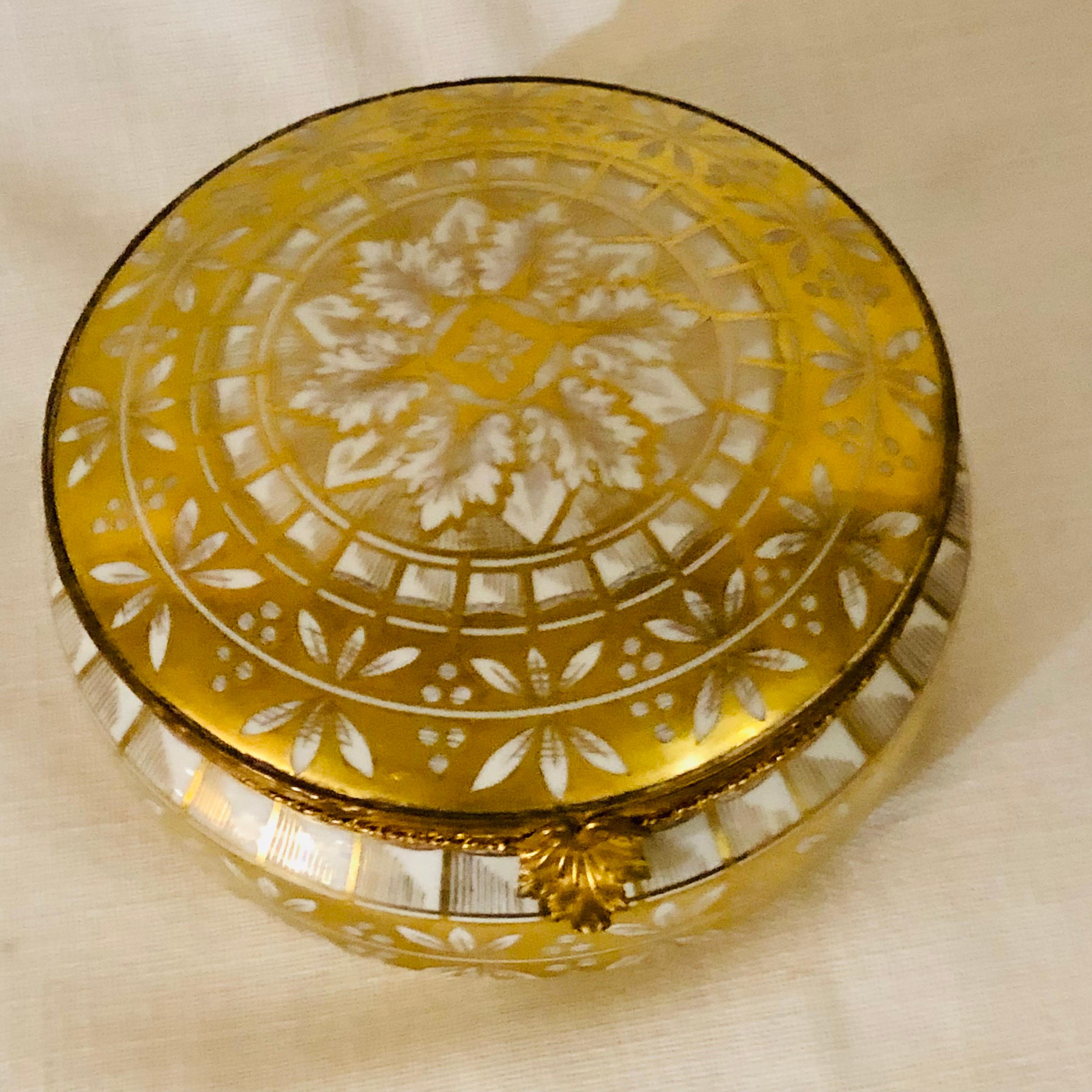 This is a stunning Le Tallec porcelain round box. It is beautifully painted with detailed gold decoration all over its sides and top. It is 6 inches in diameter. It would be a perfect place to keep your small valuable special jewelry pieces. This Le