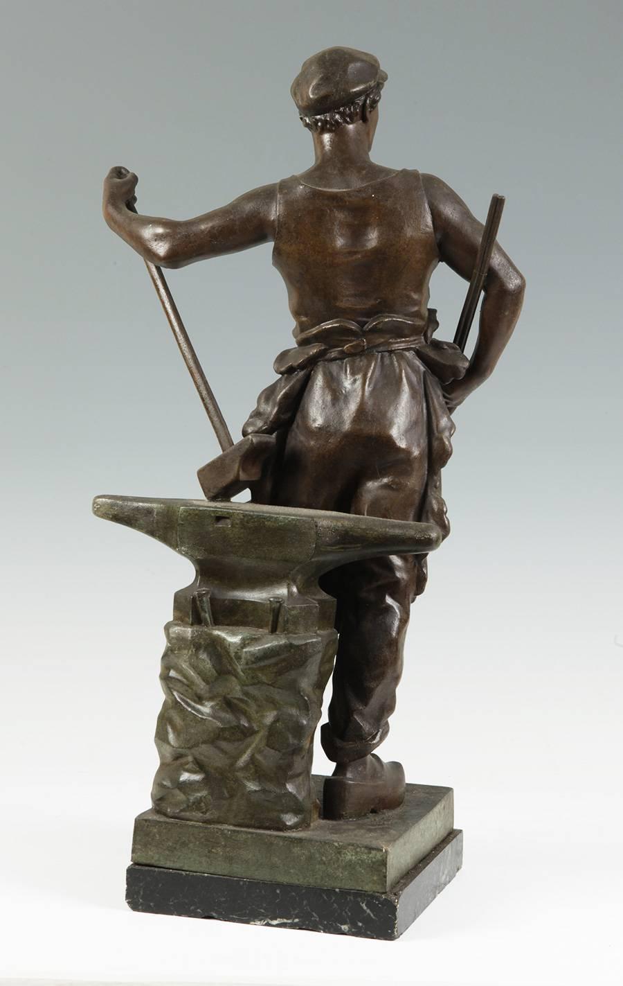 Sculpture in patinated calamine, which shows an allegory of work designed following the neoclassical art, but represents a contemporary worker, with simple clothes, wooden shoes and standing in front of an anvil, holding tongs and a large deck.