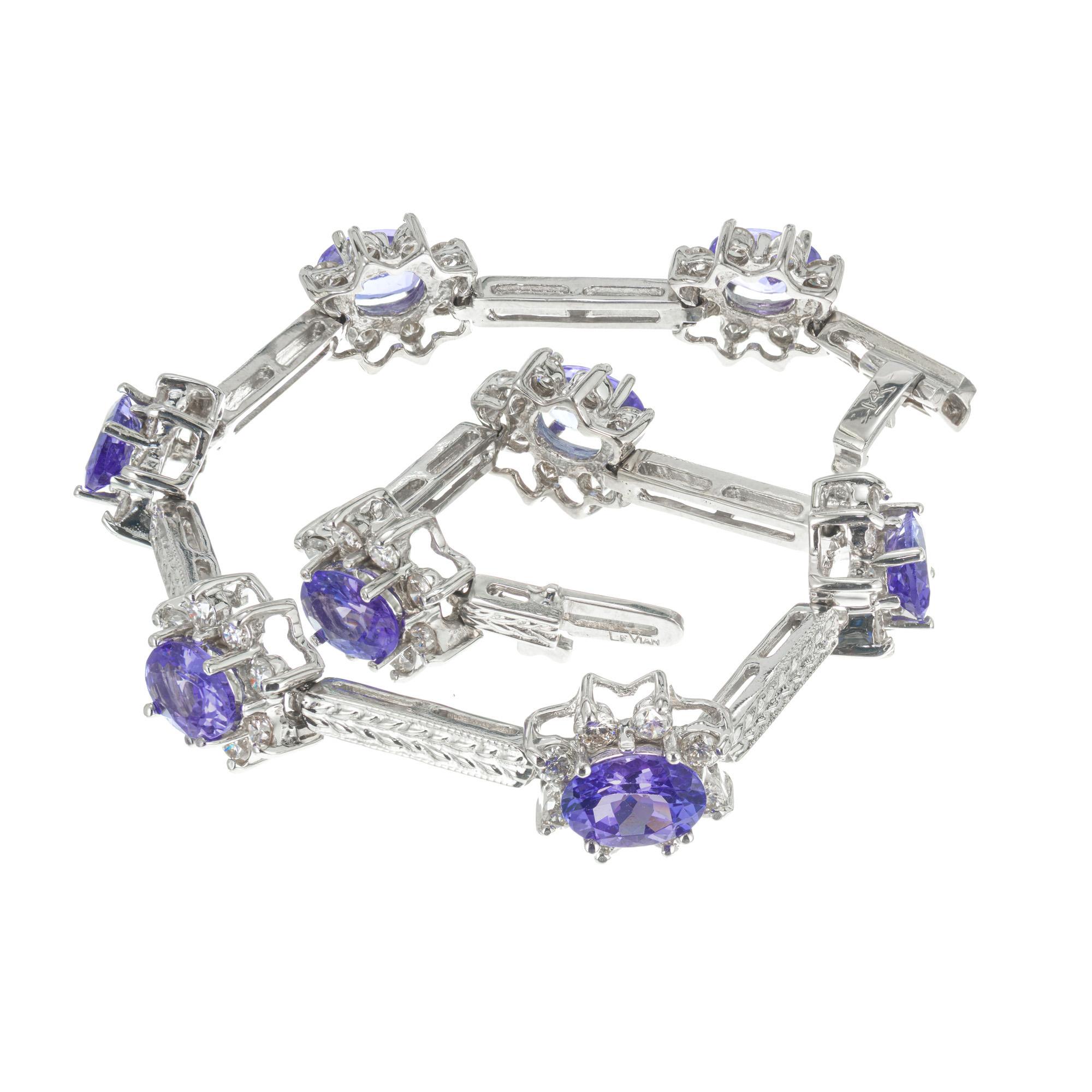 Classic Le Vian design. 8 Oval tanzanite, each one with a halo of round brilliant cut diamonds. Set in 14k white gold engraved bars. 7 inches long. 

8 oval blue tanzanite's, approx. 12.00cts
64 round brilliant cut diamonds, H-I VS SI approx.