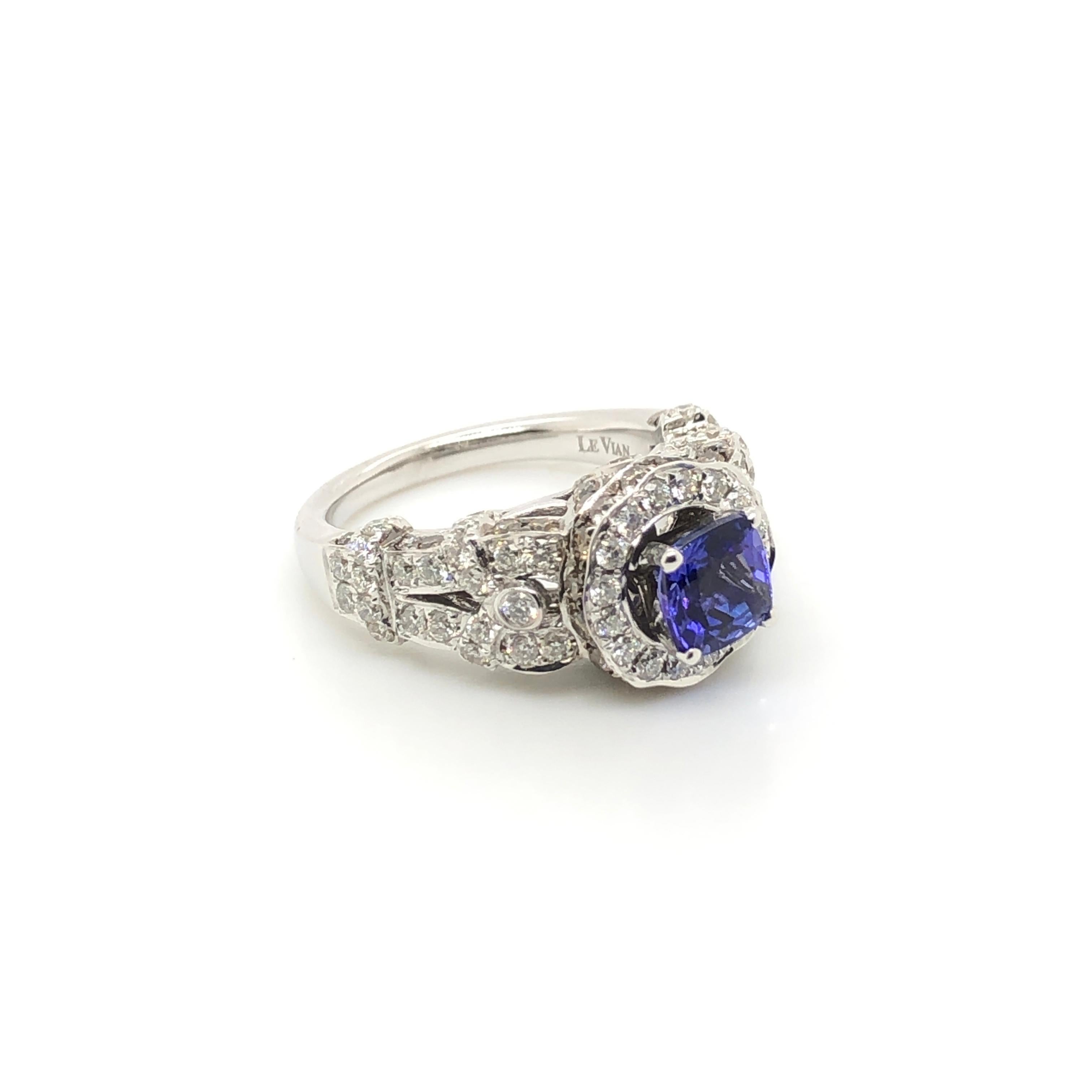 A stunning 1-1/4 carat Tanzanite rests atop the gorgeous high profile setting of this 14k white gold Le Vian Bridal ring featuring 7/8 ct. tw Chocolate Diamonds accents on the profile and 1 ct t.w. Vanilla Diamonds surrounding the center stone and