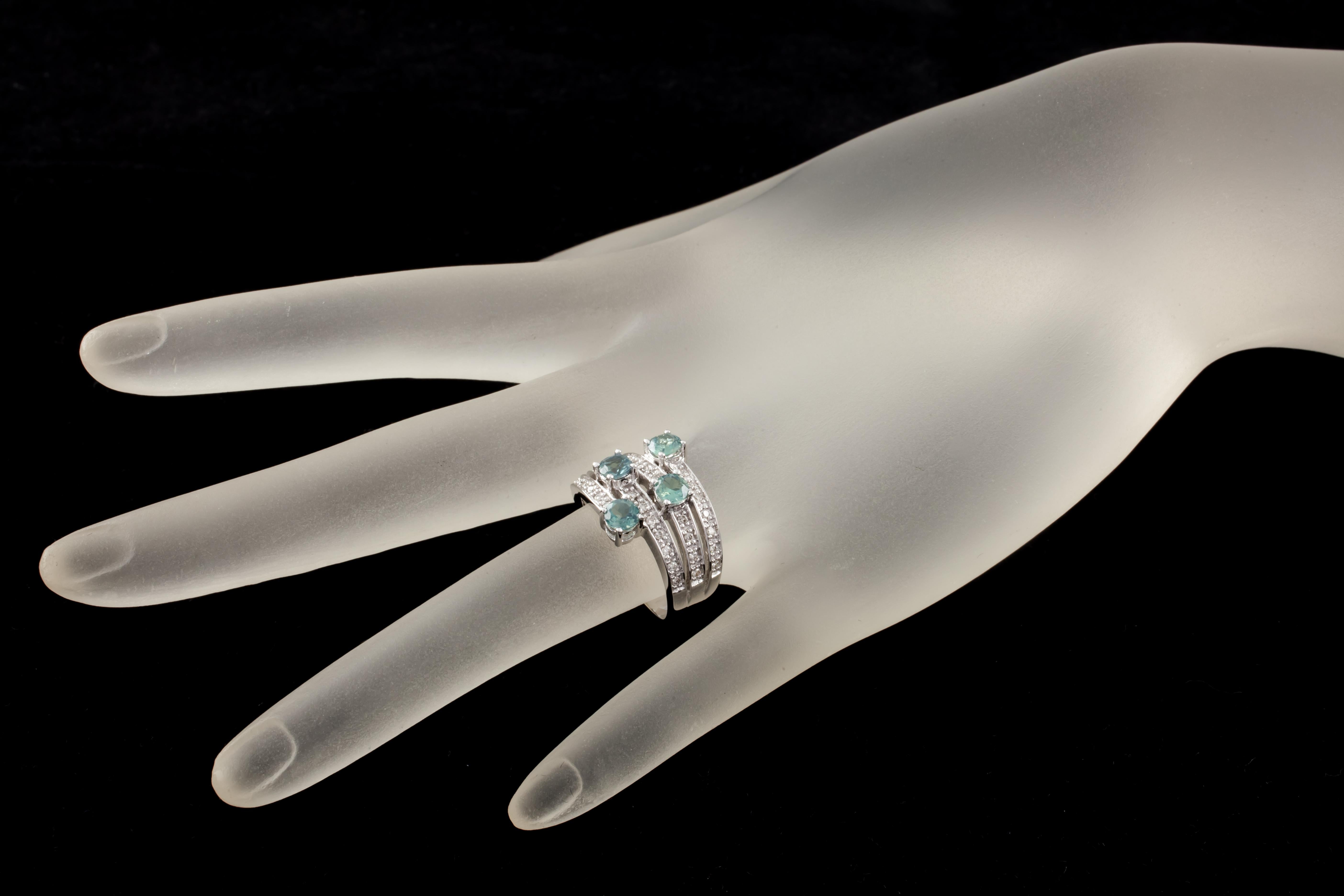 Gorgeous 14k White Gold Ring
Features Four Rows of Pave-Set Diamonds Terminating in a Prong-Set Blue/Green Stone
Width of Setting = 13 mm
Width of Band = 3 mm
Size = 6.75
Total Mass = 7.1 grams