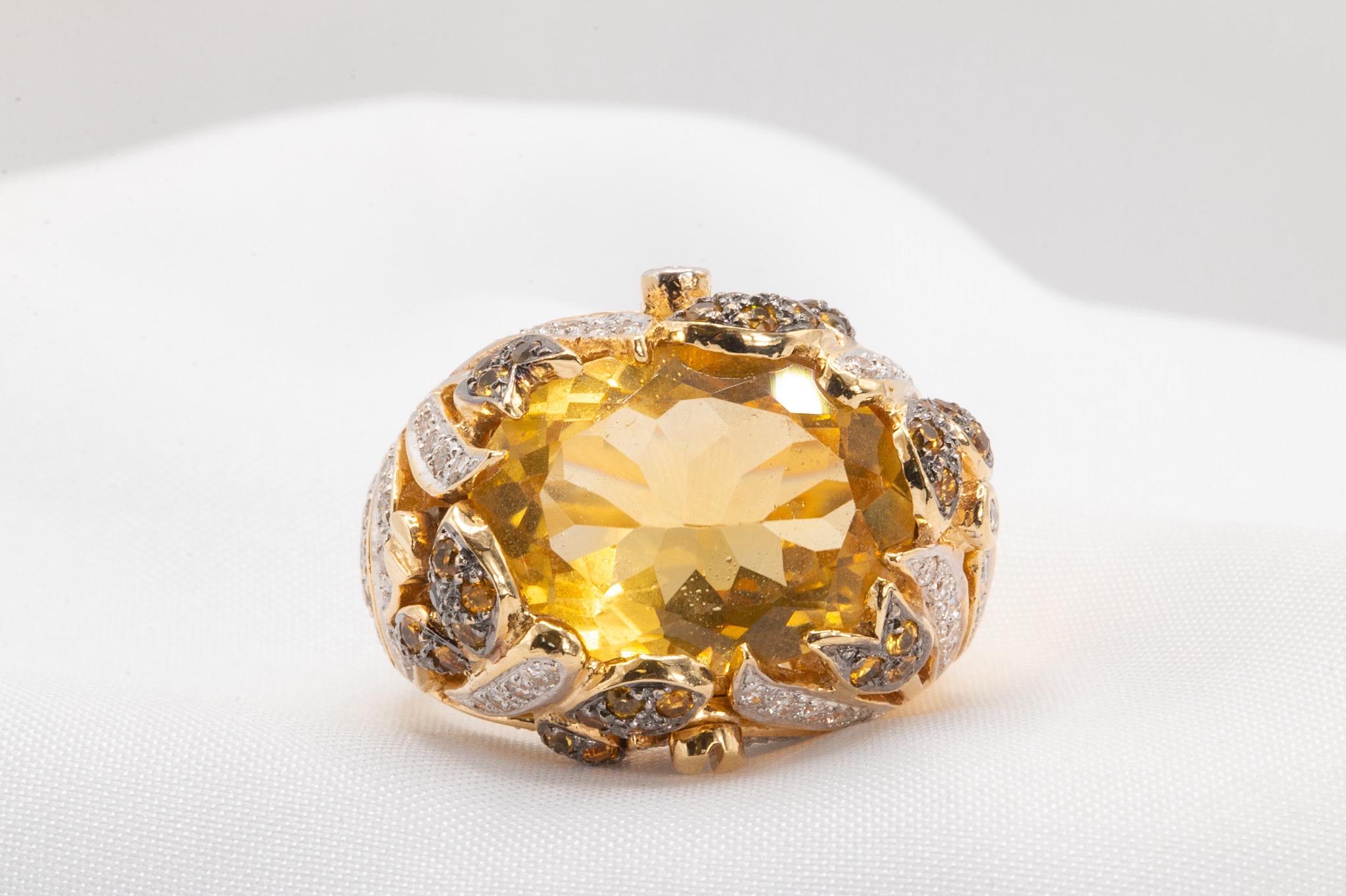 This exquisite Le Vian statement ring is crafted in 14K yellow gold and features a stunning oval-cut citrine, measuring approximately 16.3 x 12mm with an estimated weight of 12 carats. The vibrant centerpiece is elegantly framed by round