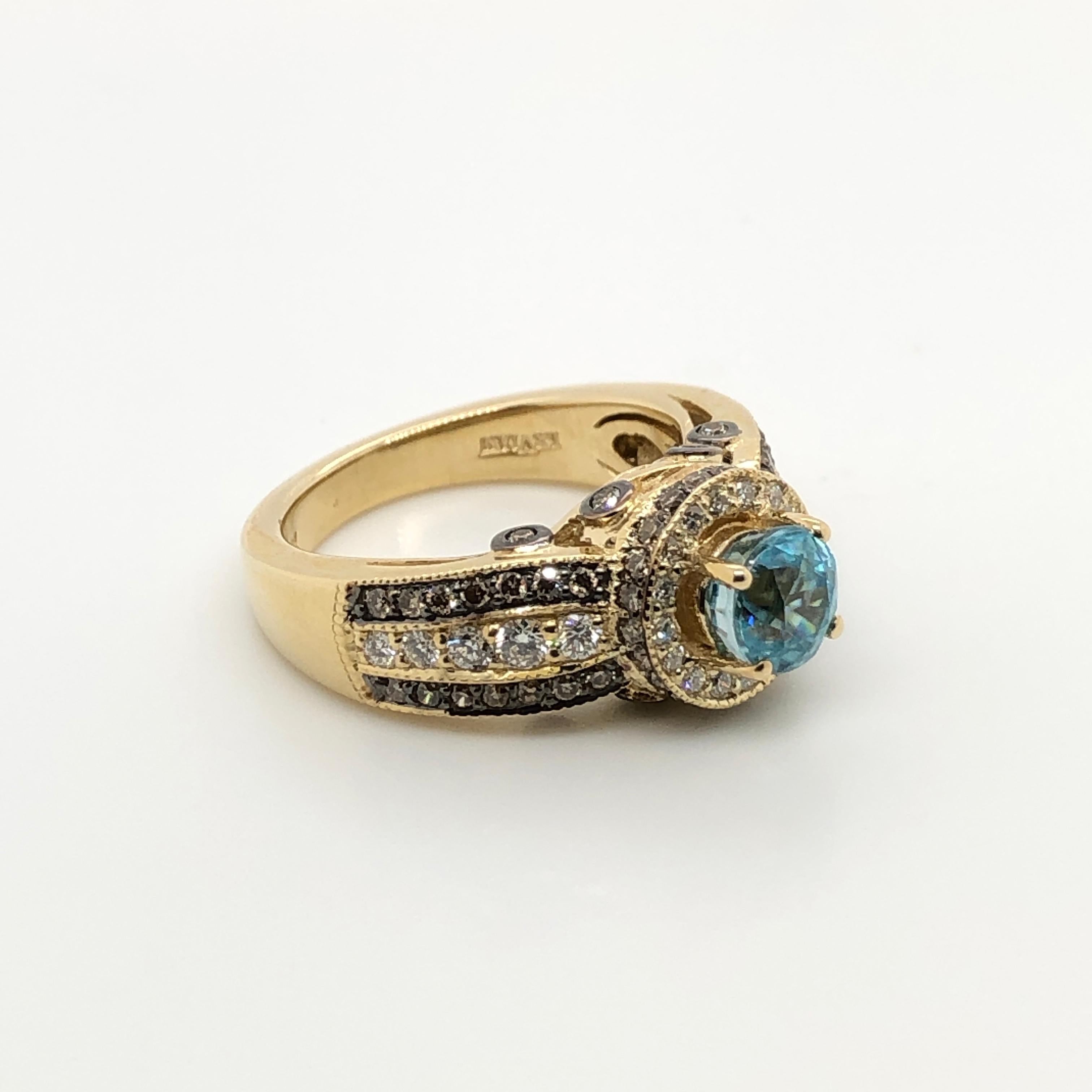 No one colors your world like Le Vian and this ring is a stunning example!  This 14k yellow gold Le Vian Chocolatier design features a gorgeous 1-7/8 carat Blue Zircon nestled within a halo of Vanilla Diamonds with a Chocolate Diamonds and Vanilla